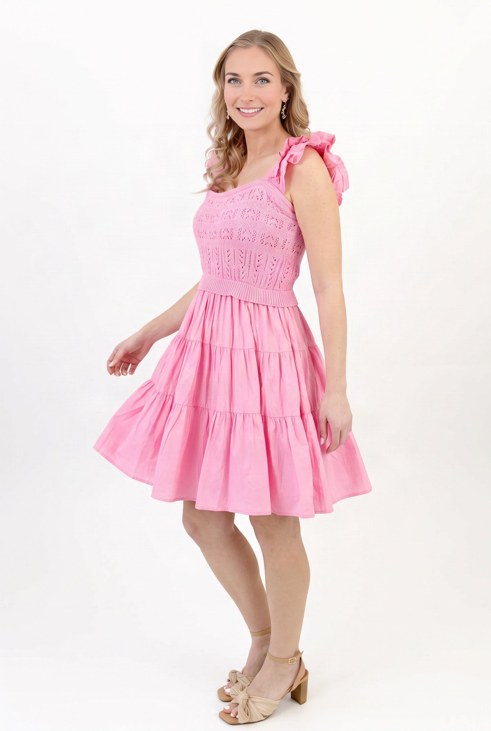 Angled side fit of the pink crochet dress in Small, showing the fitted bodice and skirt volume.
