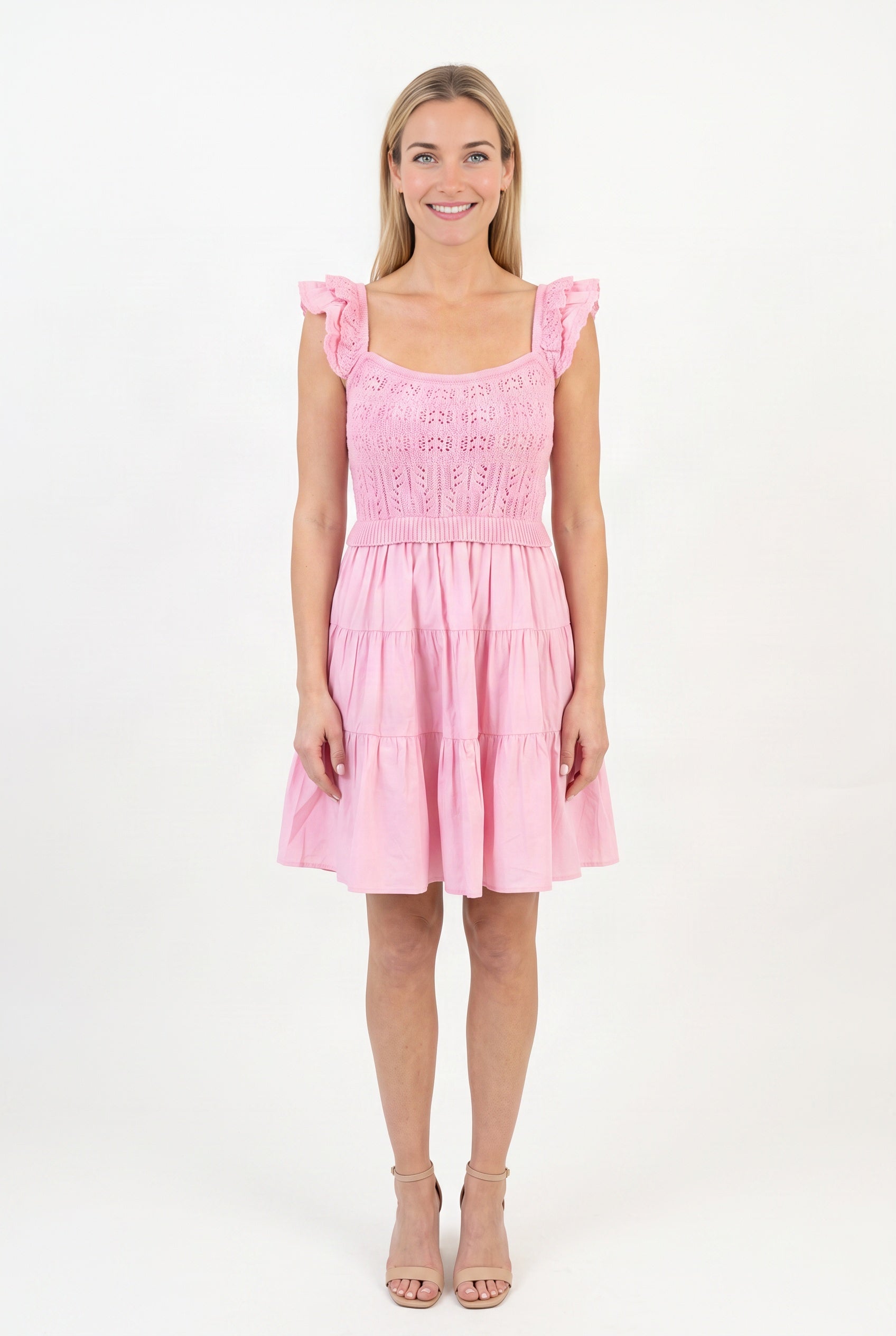 Front fit of the Completely In Tune pink crochet dress in Small, showing its square neck and tiered skirt.