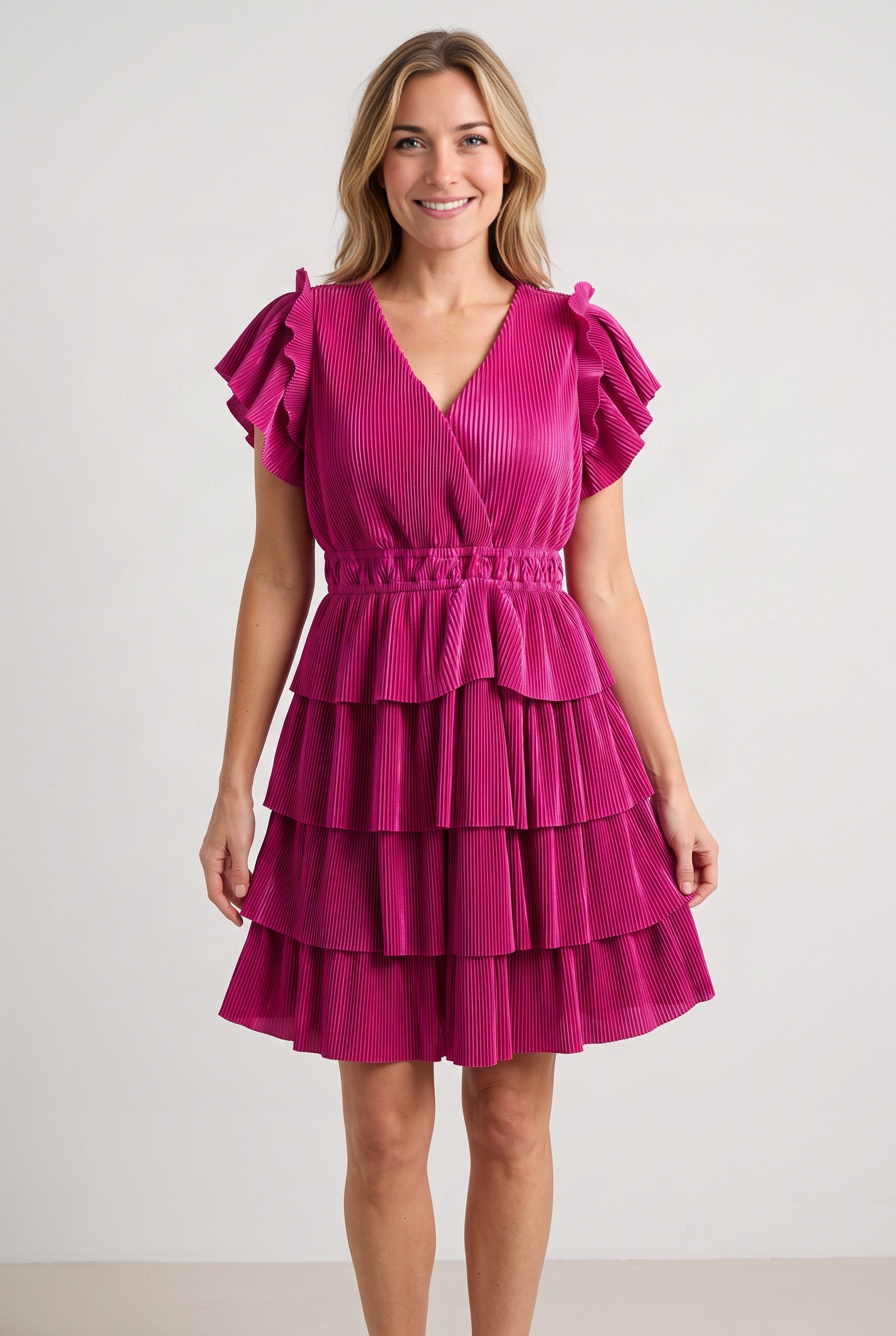 Front fit of the magenta tiered dress in size Small, showing the V-neck, elastic waist and above-knee hem.