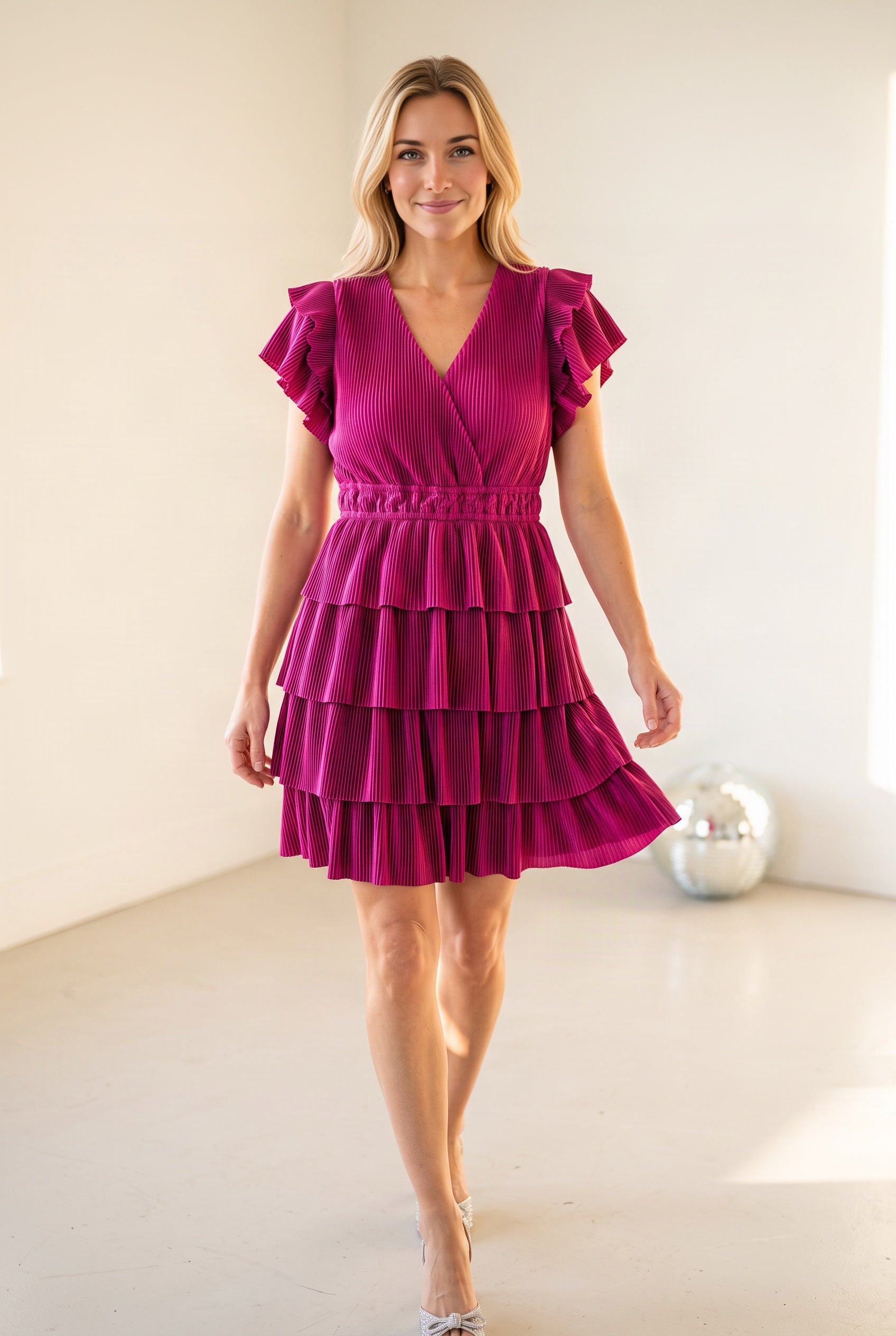 Elsa walking in the magenta tiered party dress as the pleated ruffles move around the legs.