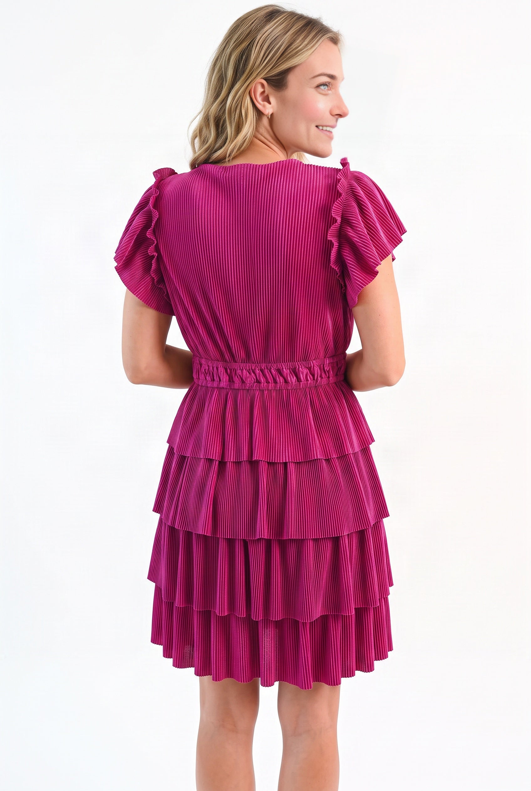 Back fit of the magenta tiered dress showing the closed neckline, elastic waist and layered skirt.
