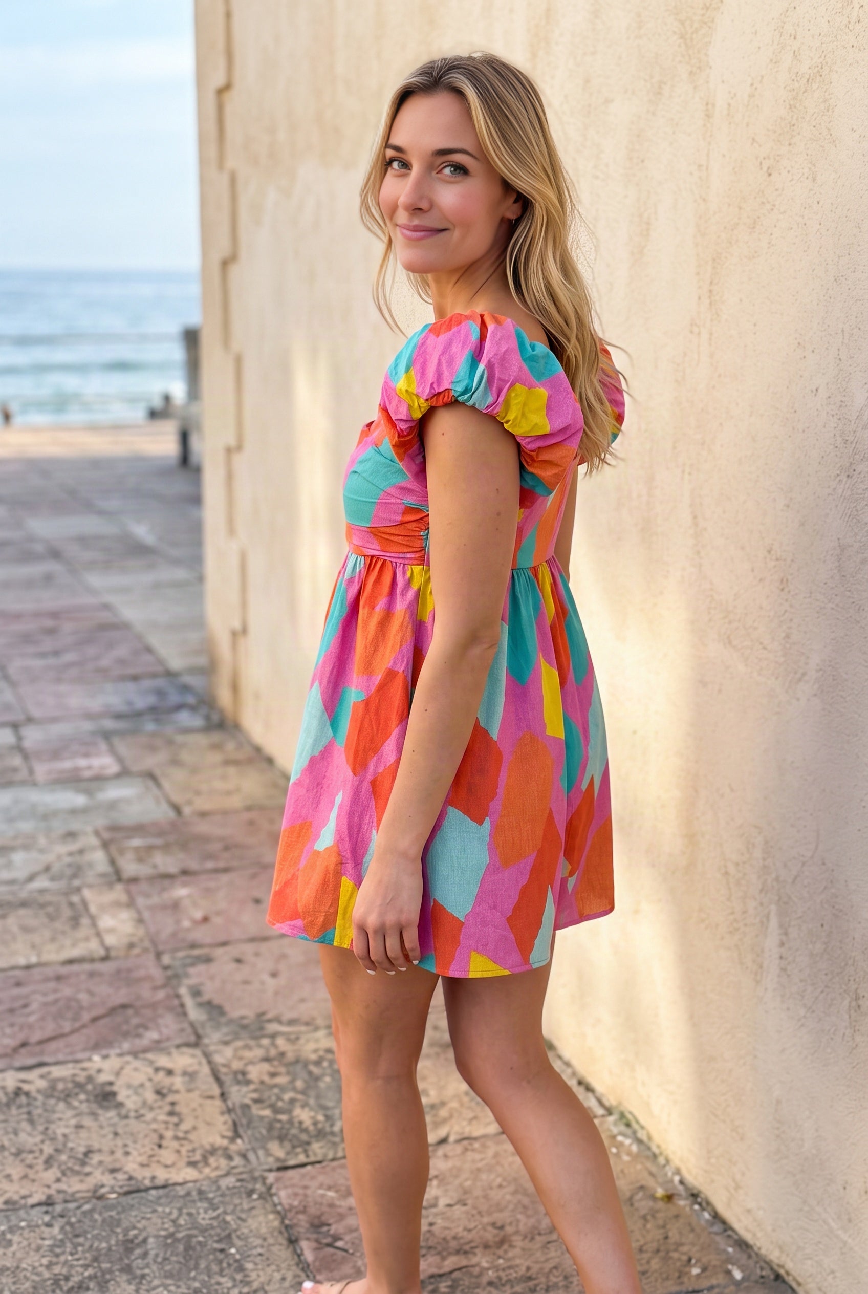 Angled side fit of the All My Days Colorful Romper showing its high waist and flared shorts.