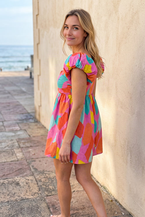Angled side fit of the All My Days Colorful Romper showing its high waist and flared shorts.