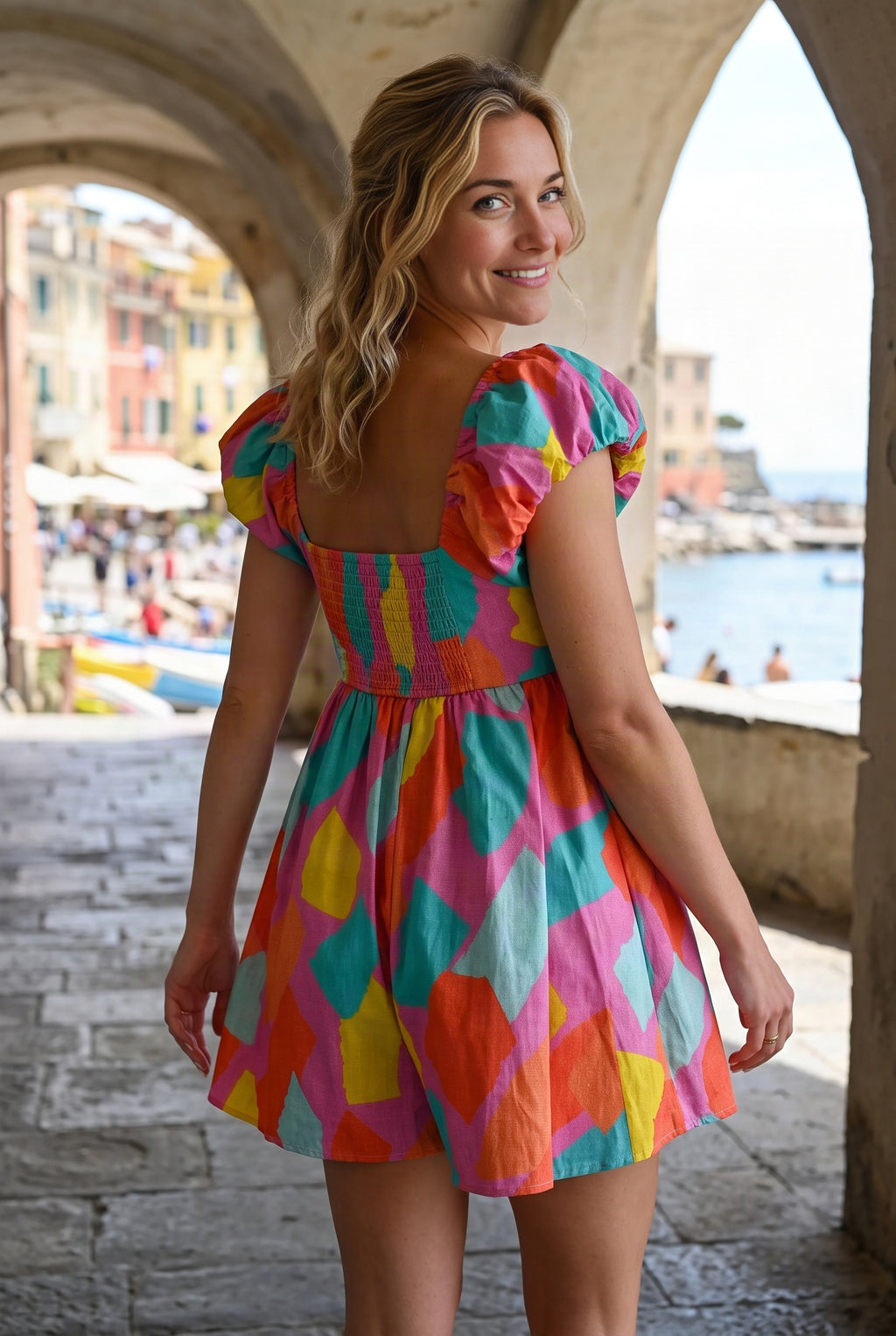 Rear three-quarter fit of the All My Days Colorful Romper showing its square back and smocked bodice.