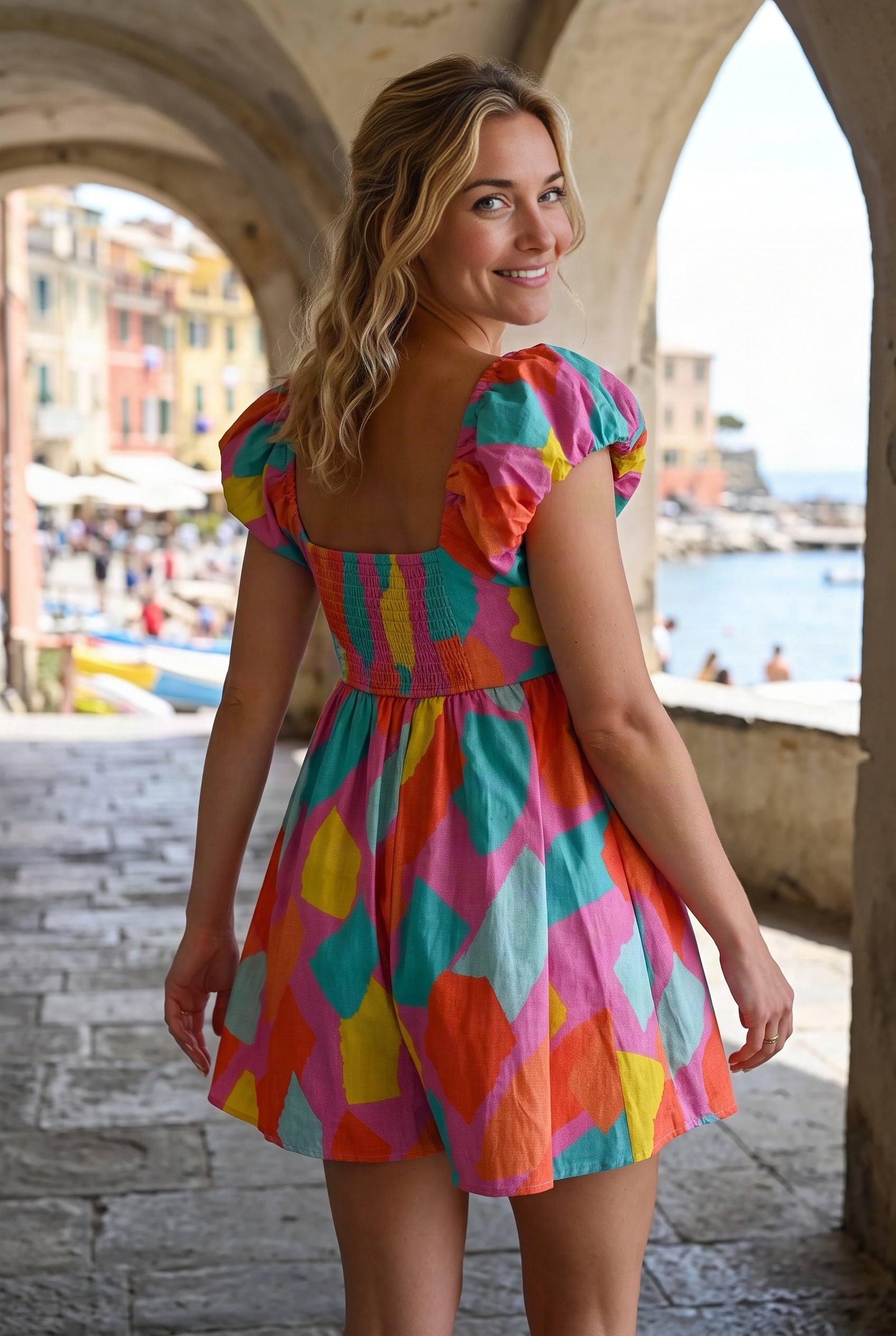 Rear three-quarter fit of the All My Days Colorful Romper showing its square back and smocked bodice.