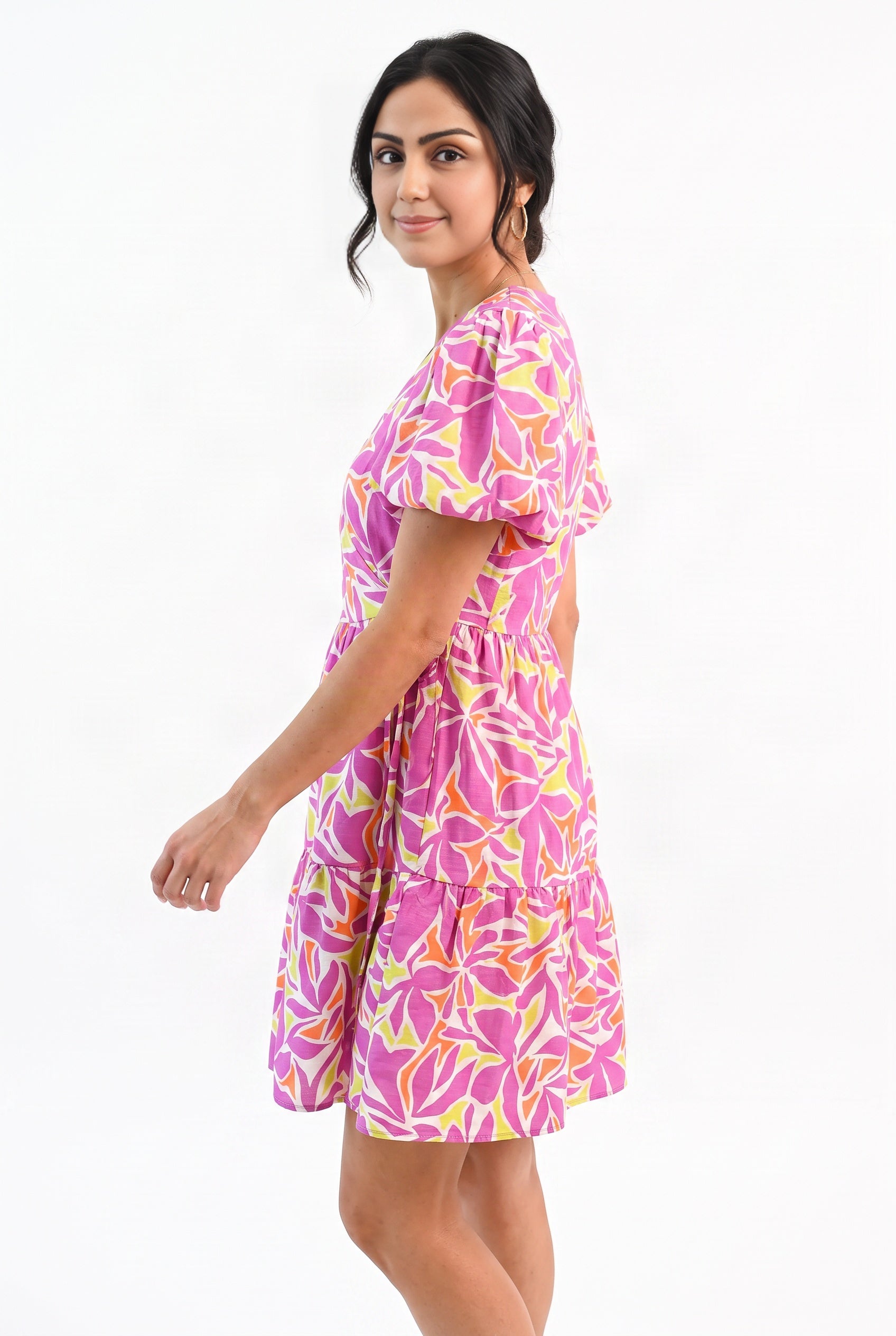 Angled side fit of the Somewhere Sunny dress showing puff-sleeve projection and short hem.