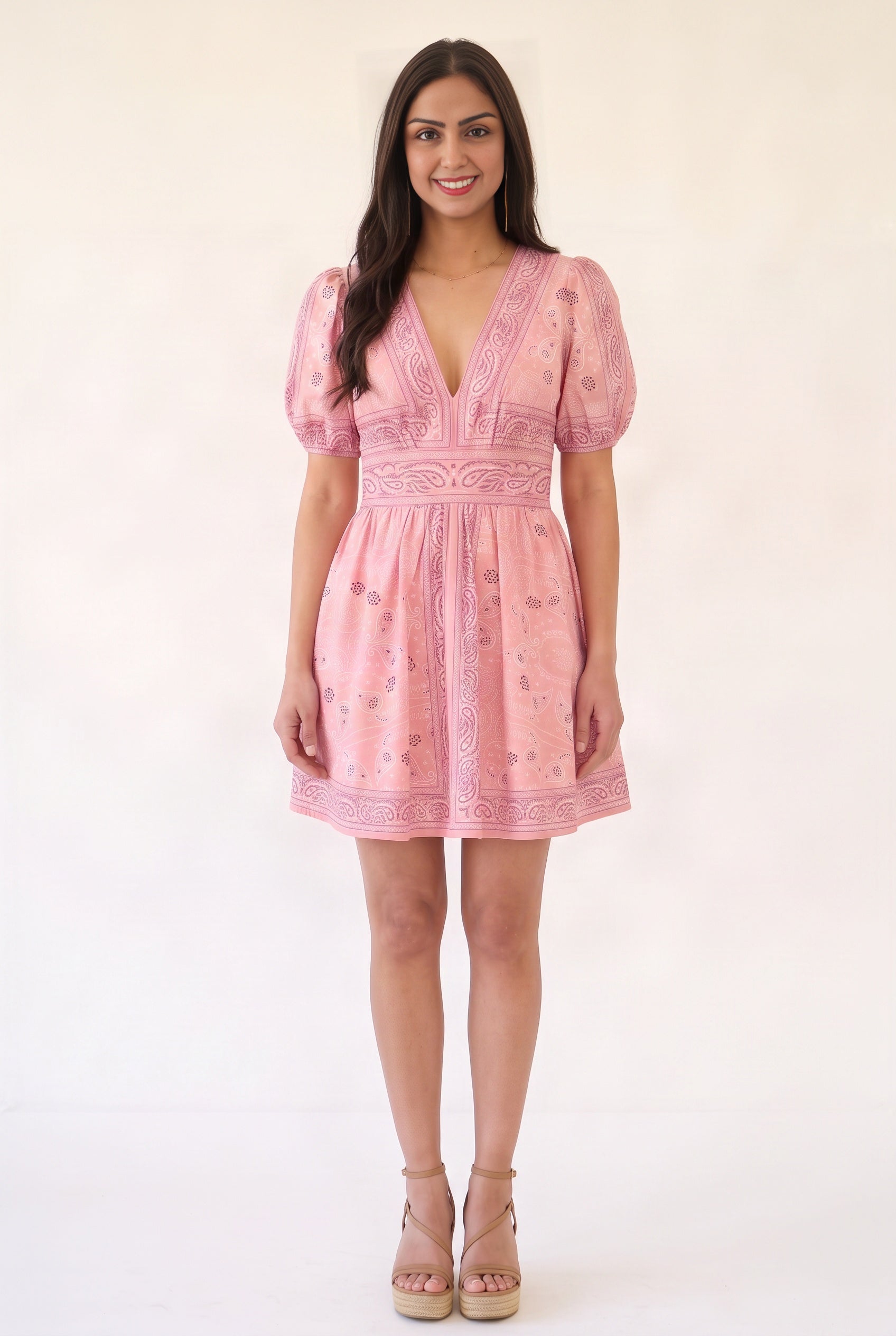 Front fit of the pink Forget Me Not Paisley Dress showing its V-neck, defined waist, puff sleeves and mini hem.