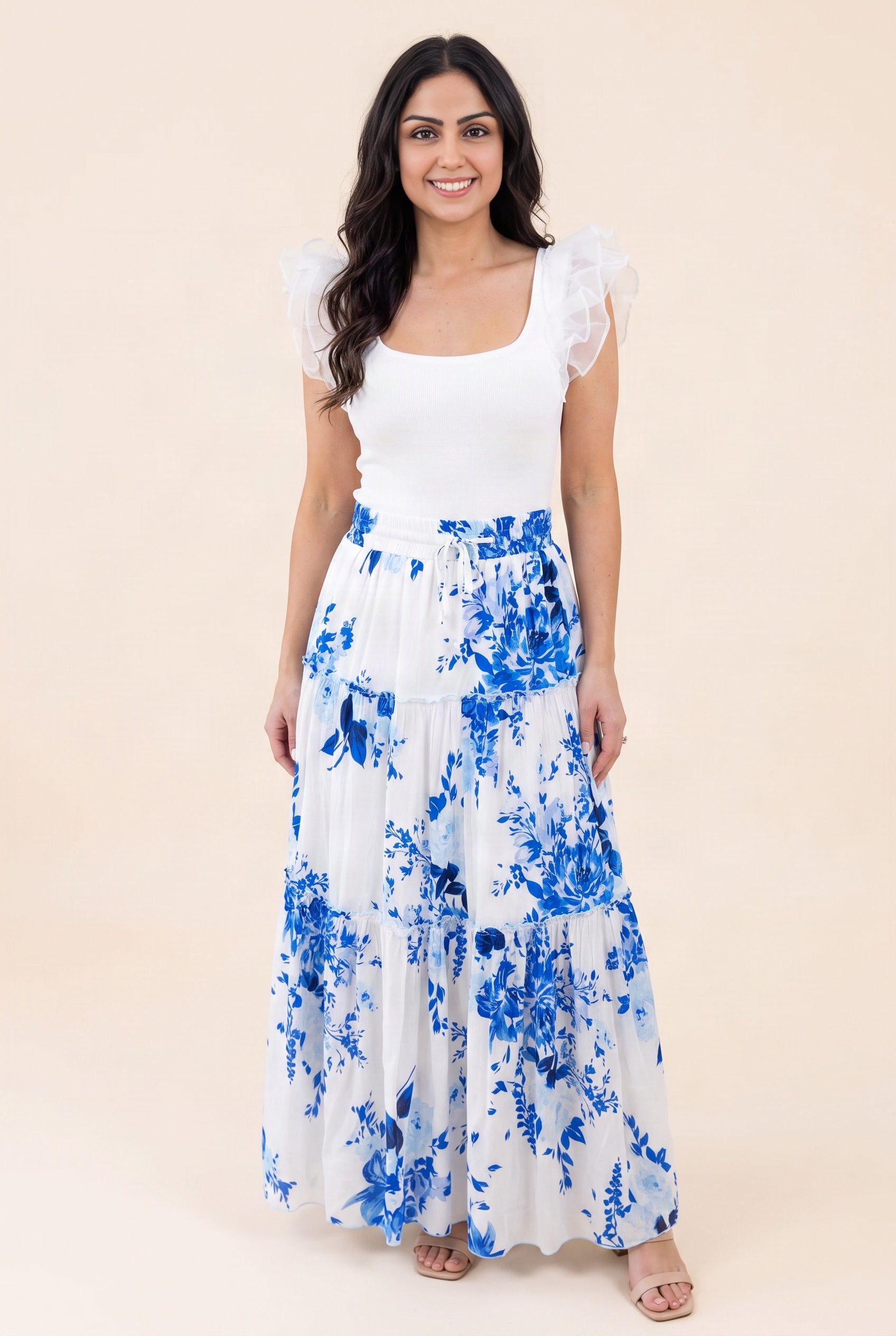 Shweta wearing the blue floral tiered maxi skirt in Small, showing the front fit and full length.