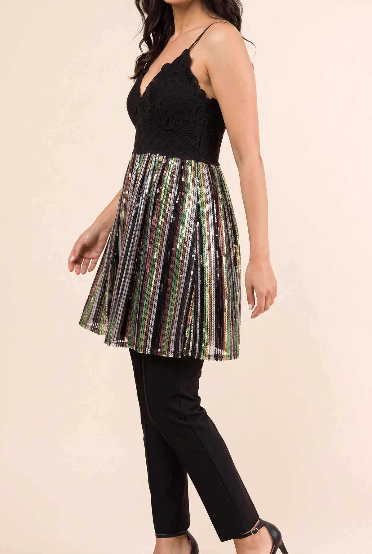 Angled fit of the Small sequin tunic top showing its side depth, empire seam and flared shape.