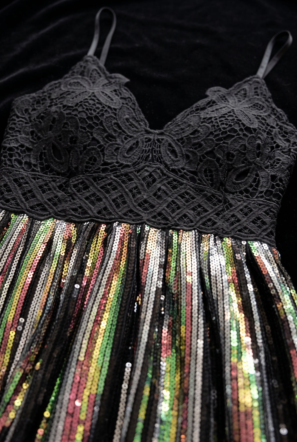 Close detail of the sequin tunic top showing floral lace, the empire seam and multicolour sequin rows.