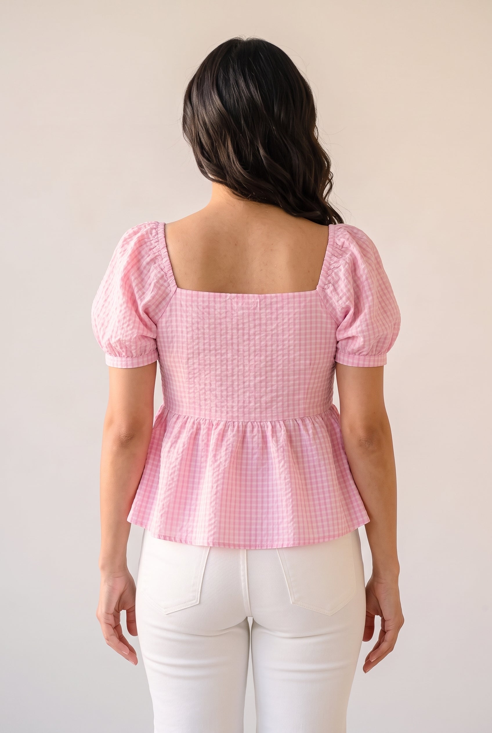 Back fit of the Blushing For You pink gingham top in Small, showing its neckline, shaping and peplum.