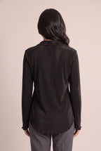 Back fit of the Small Black pleated top showing its clean back and longer rounded shirttail hem.