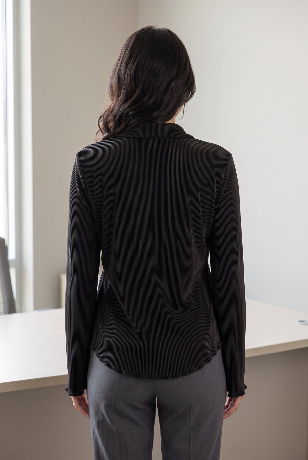 Small Black Rolling in the Deep Pleated Top styled untucked with tailored grey trousers for work.