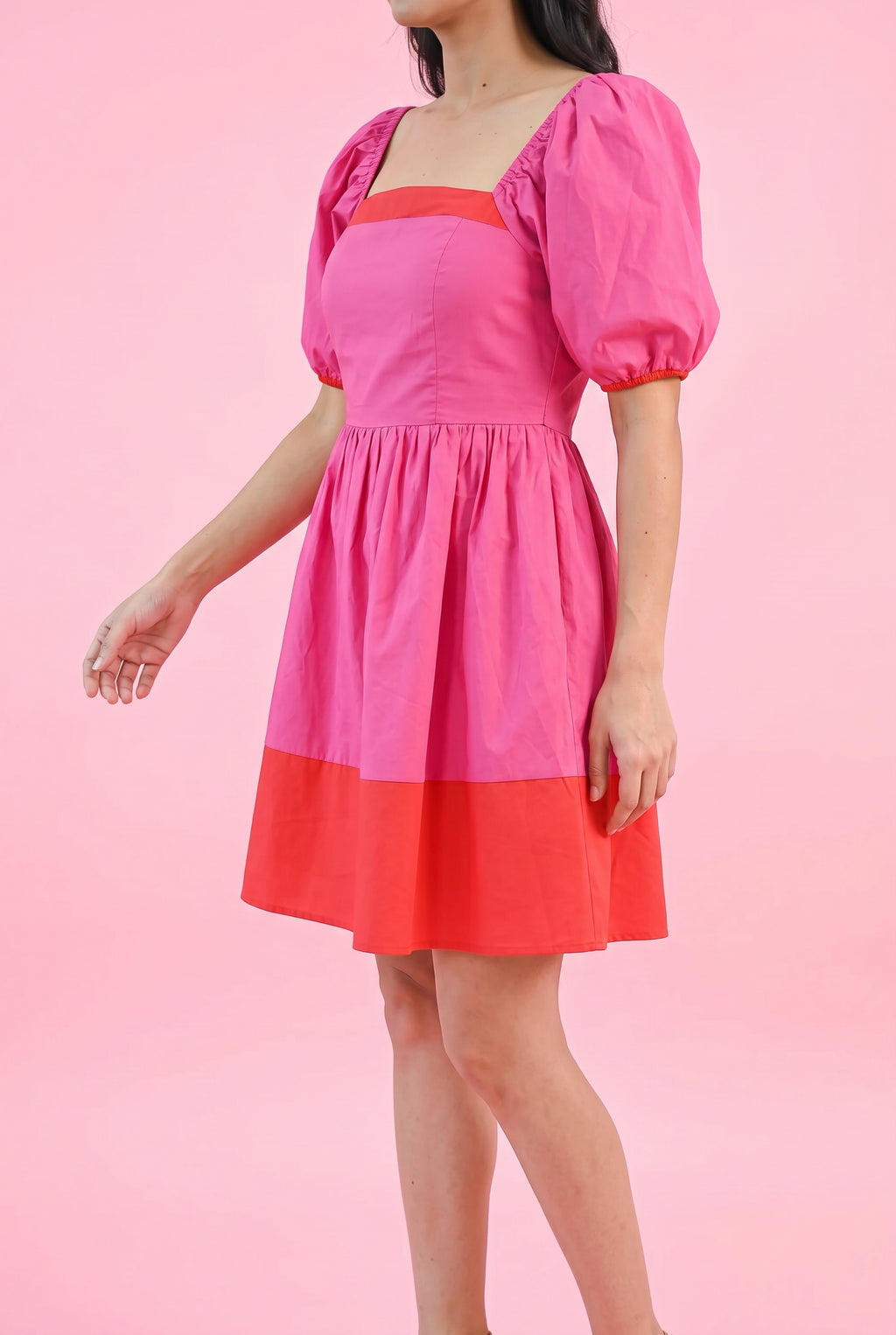 Angled side fit of the Small Magenta dress showing the puff sleeve volume, waist and flared skirt.