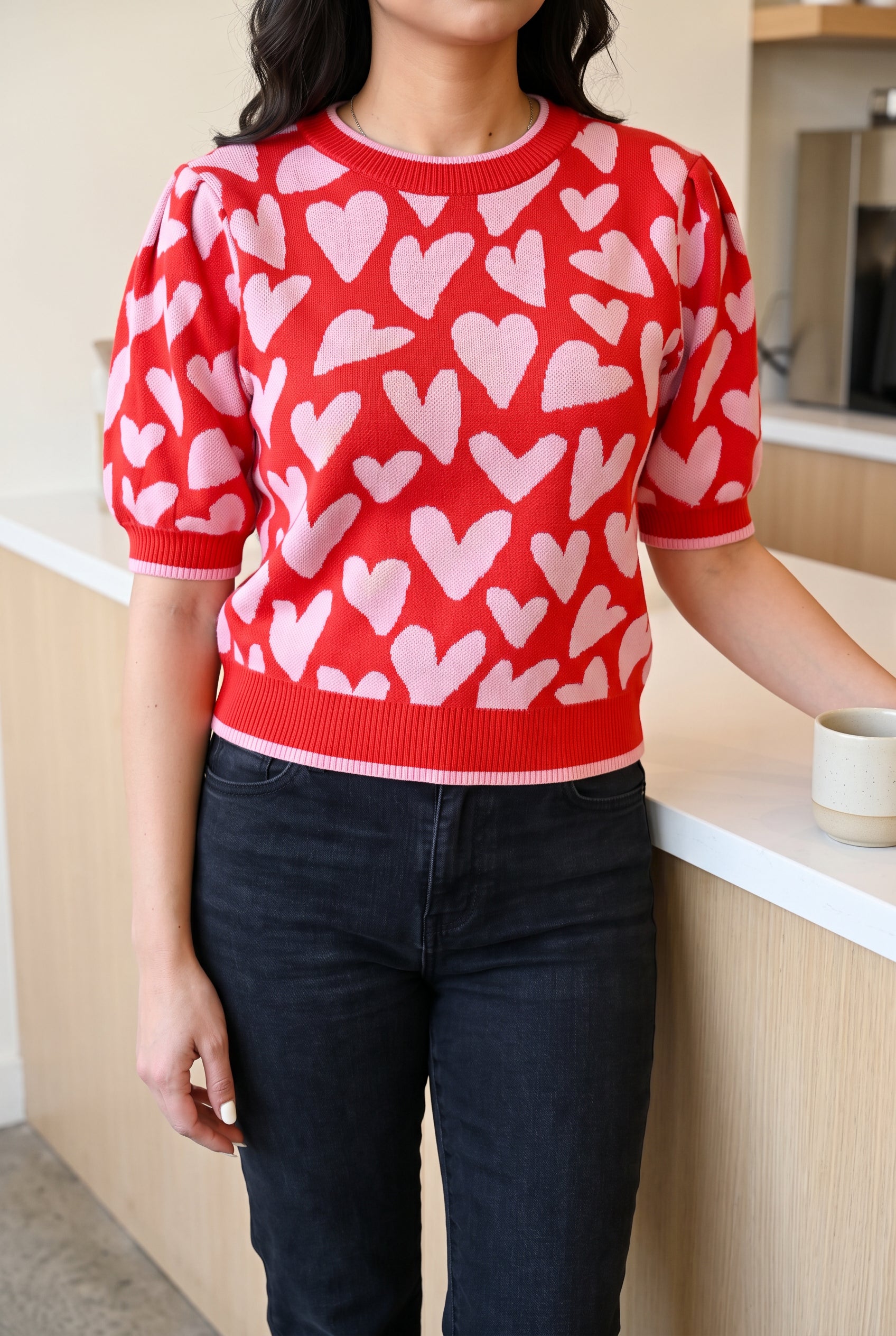 Neck-down coffee-date styling of the heart puff-sleeve sweater in Small with dark jeans.