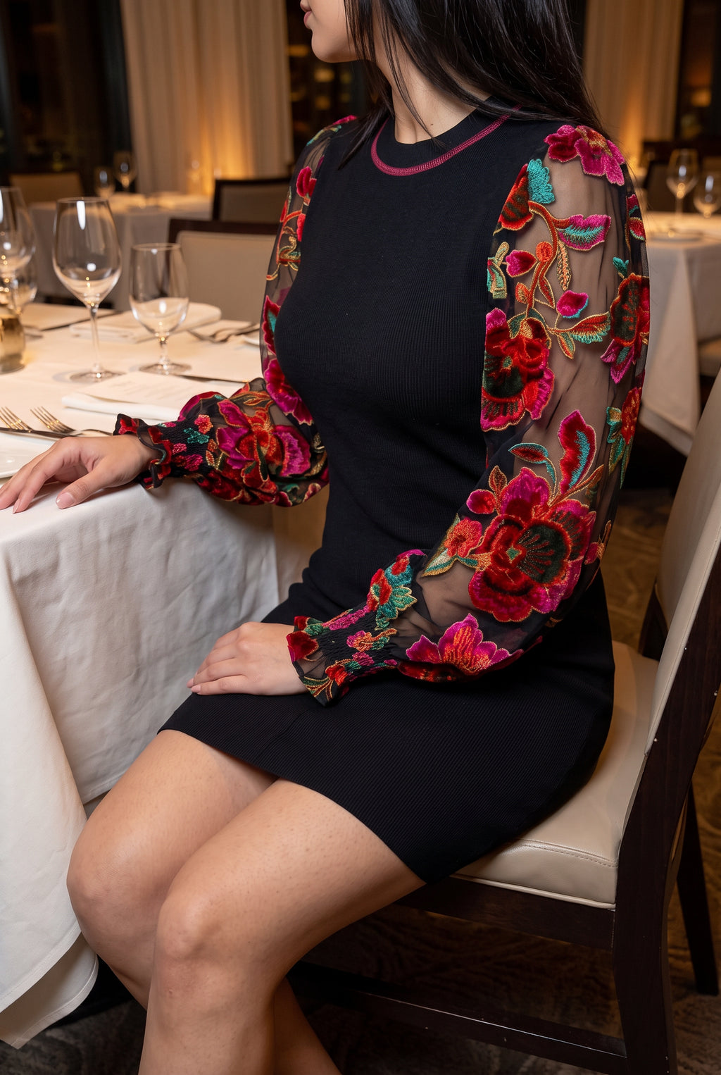 You're My Favorite Sweater Dress worn seated at dinner, showing hem coverage and statement sleeves.
