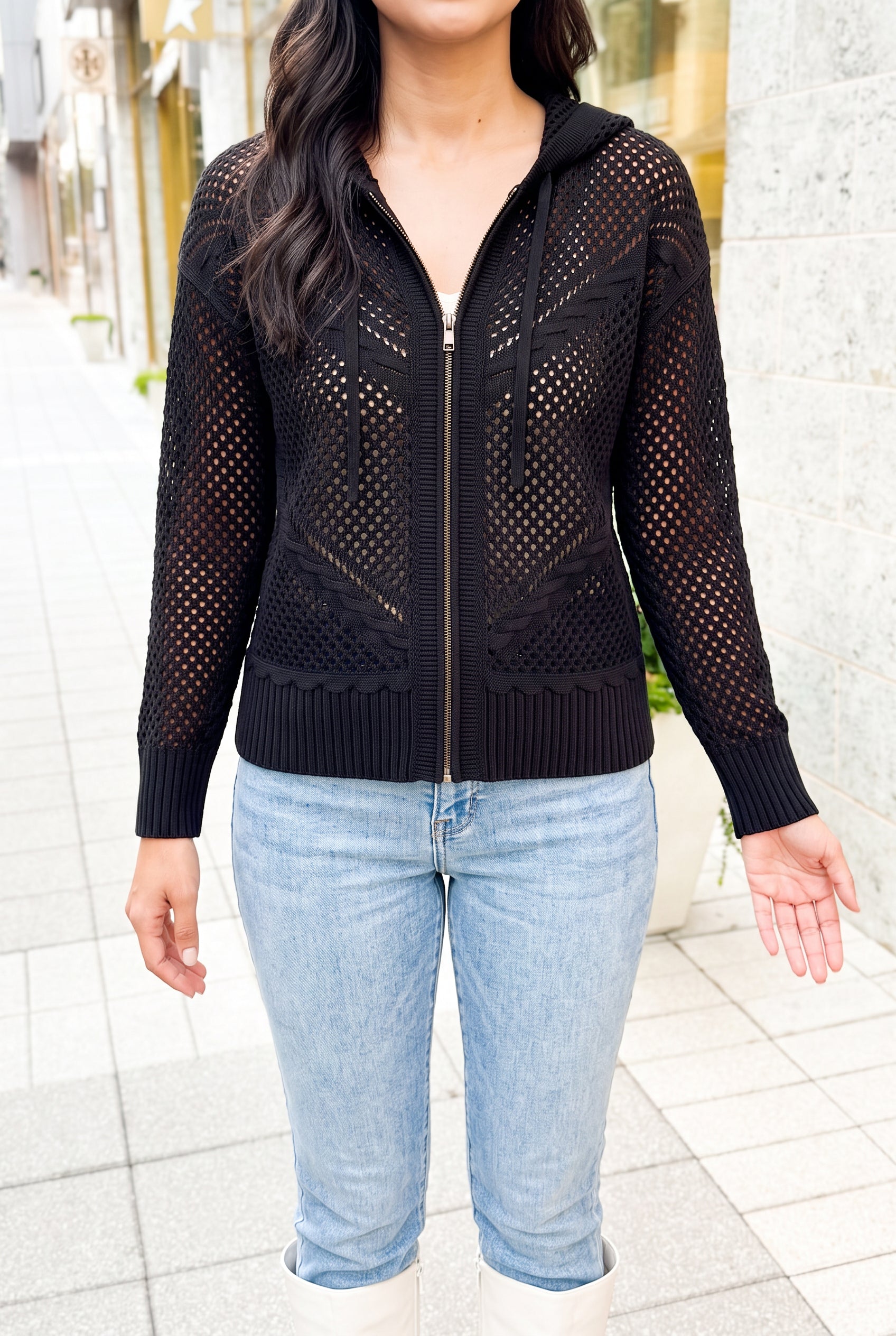 Got My Reasons Crochet Zip Hoodie with a hand behind the open crochet sleeve to show transparency.
