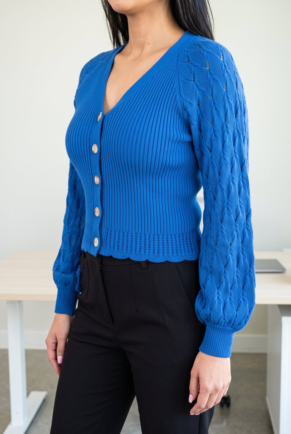 Tell Me About It Sweater Top in side profile showing the fitted body, balloon sleeve and untucked hem.