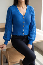 Tell Me About It Sweater Top worn seated, showing how the fitted body and sleeves settle at a desk.