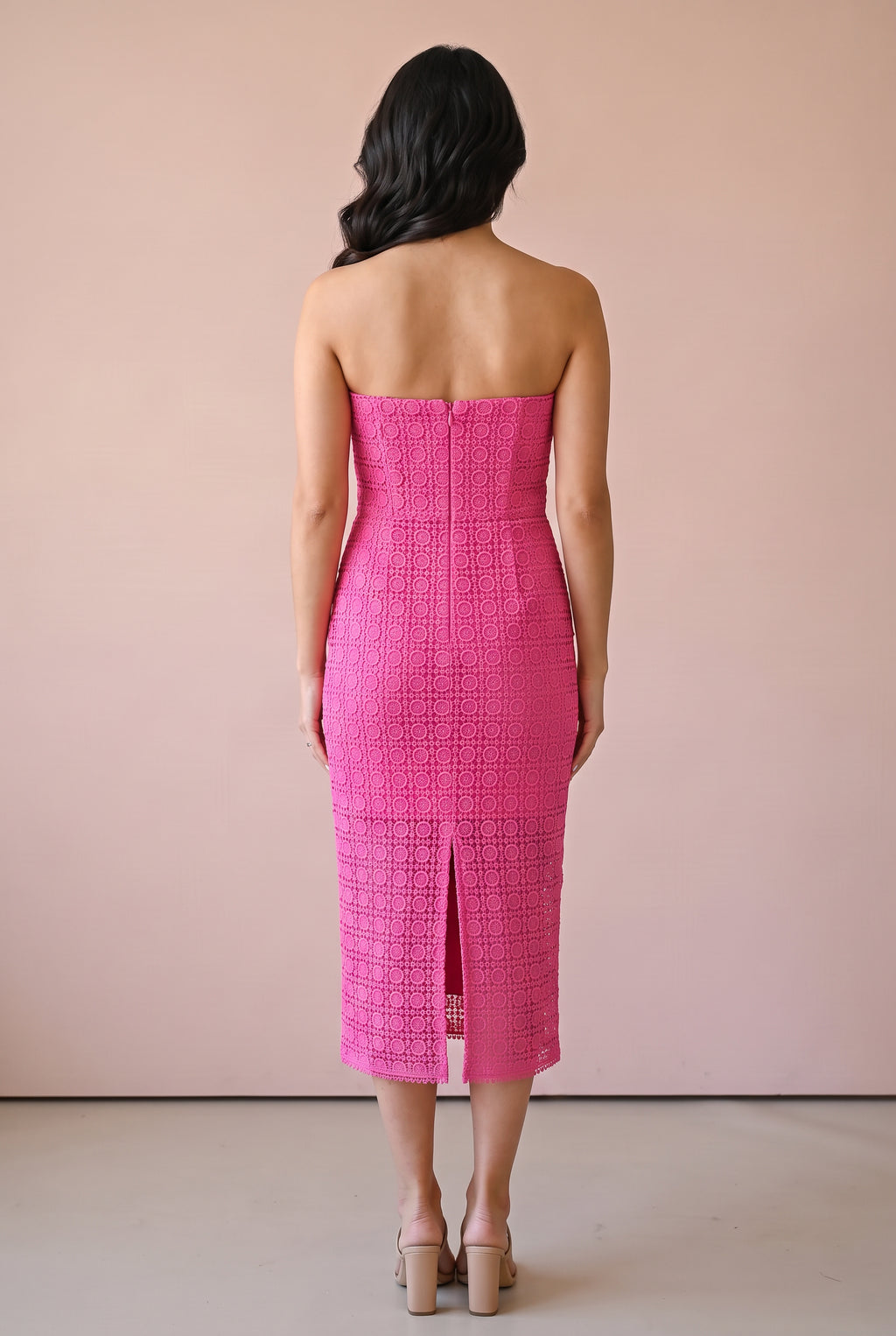 Back of the Kiss Me More pink lace midi dress showing the concealed zipper and center-back slit.