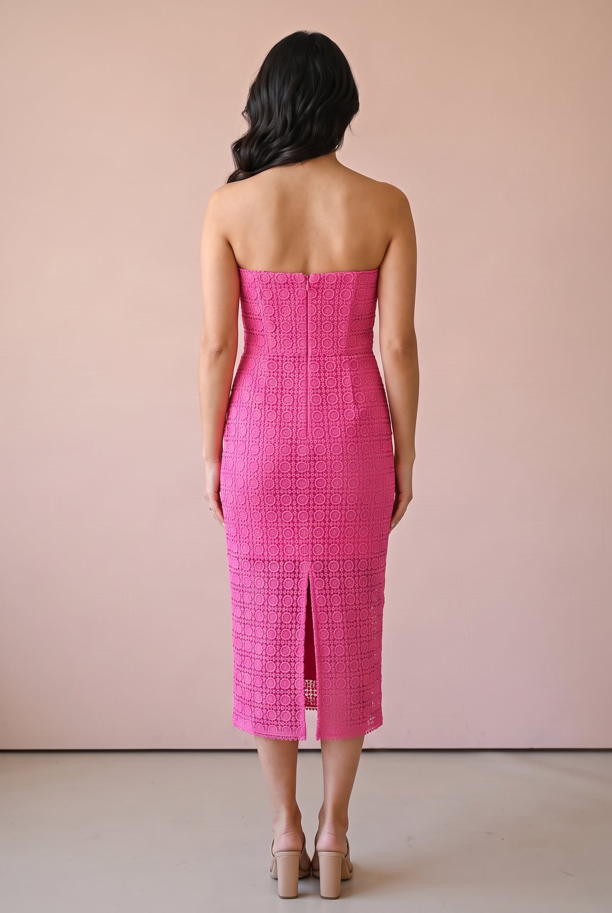 Back of the Kiss Me More pink lace midi dress showing the concealed zipper and center-back slit.