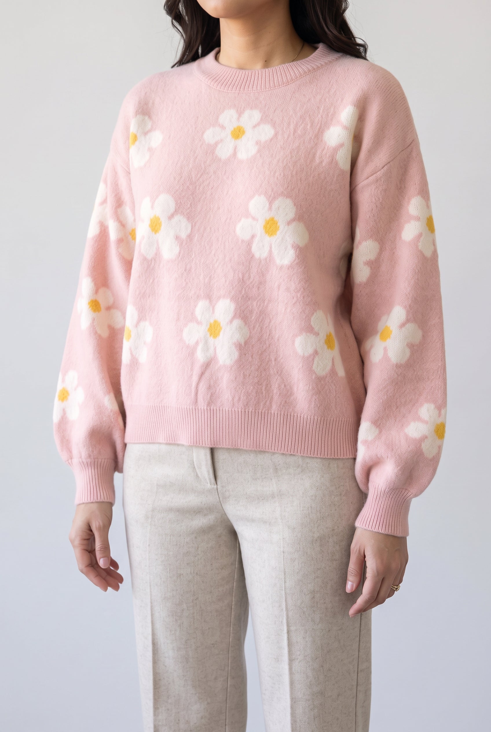 Let's Just Stay Floral Sweater worn untucked, showing the wide ribbed hem and relaxed drape over trousers.