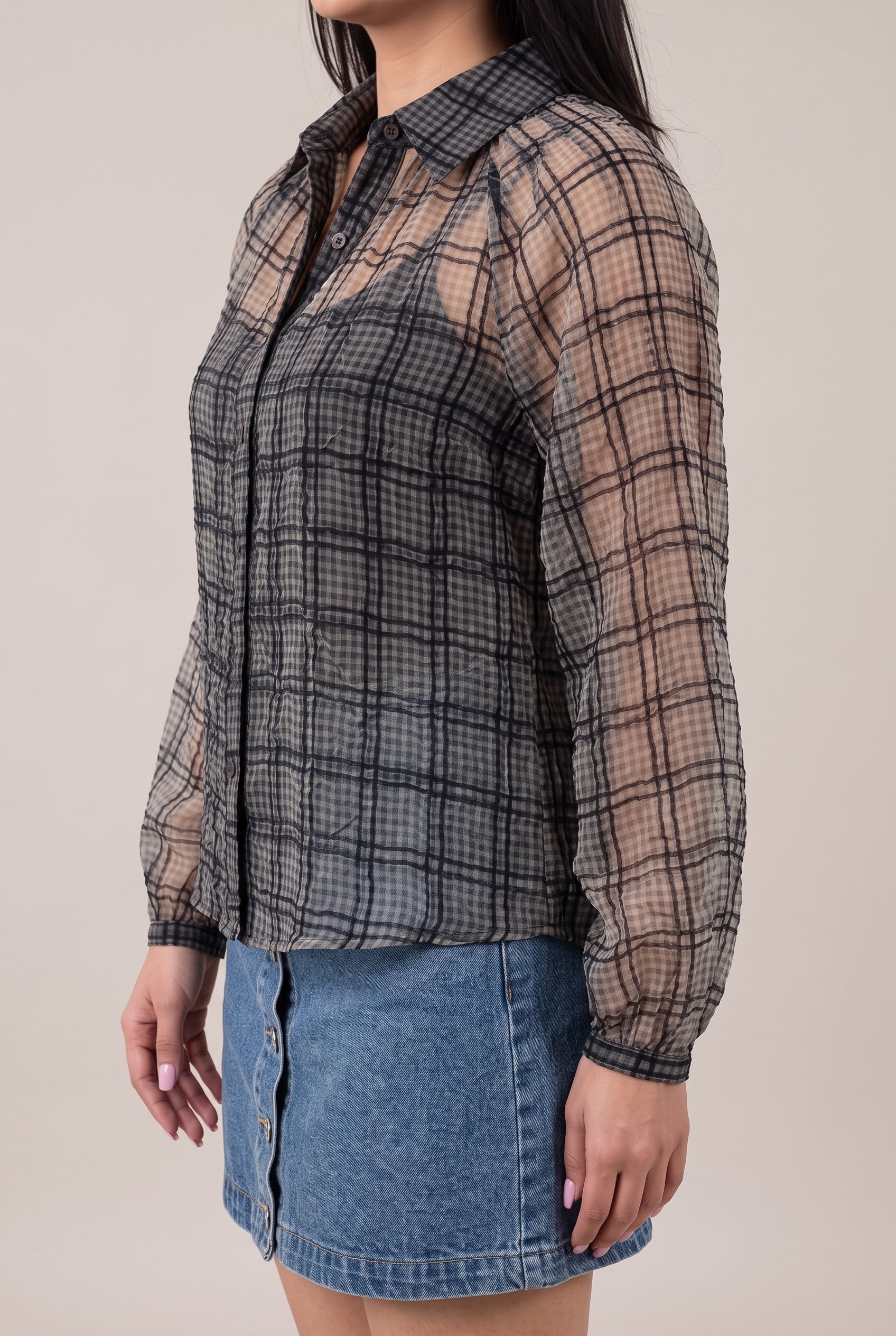 Angled side fit of the Just Looking sheer plaid blouse showing sleeve volume, body depth and curved hem.