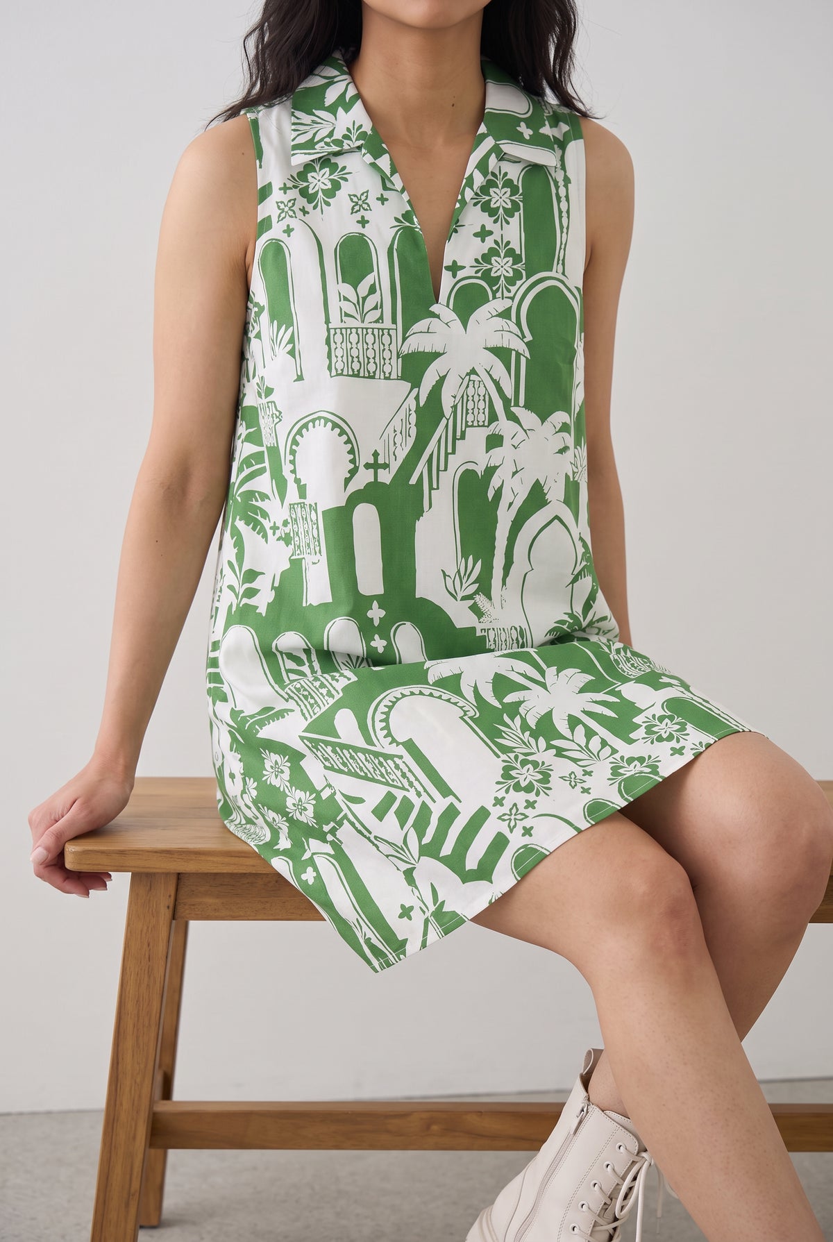 Seated view of the Pick Of The Summer Mini Dress showing armhole coverage and hem behavior.