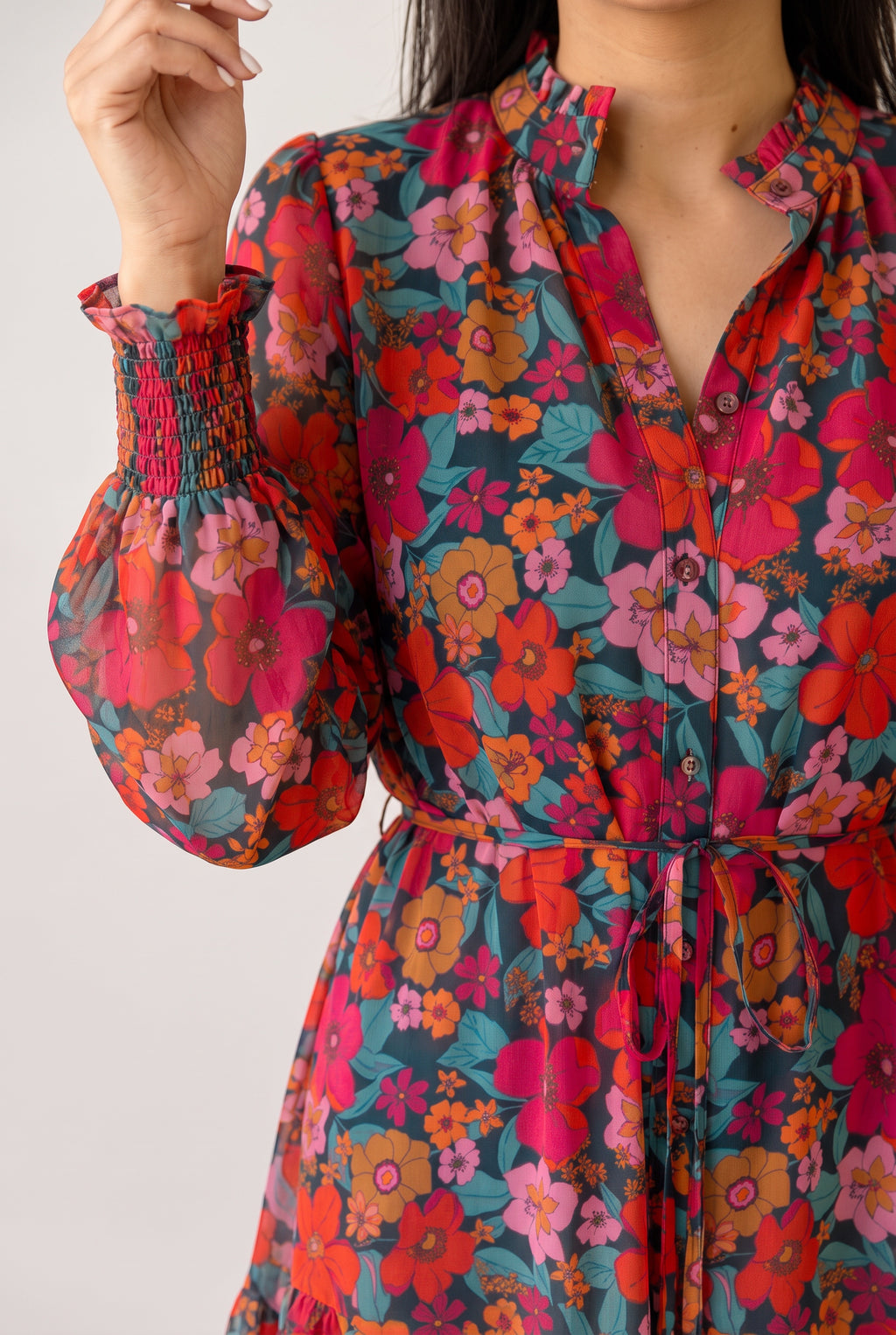 Neckline, buttons and smocked cuff of the Only If You Knew Floral Dress, showing the sheer printed sleeve.