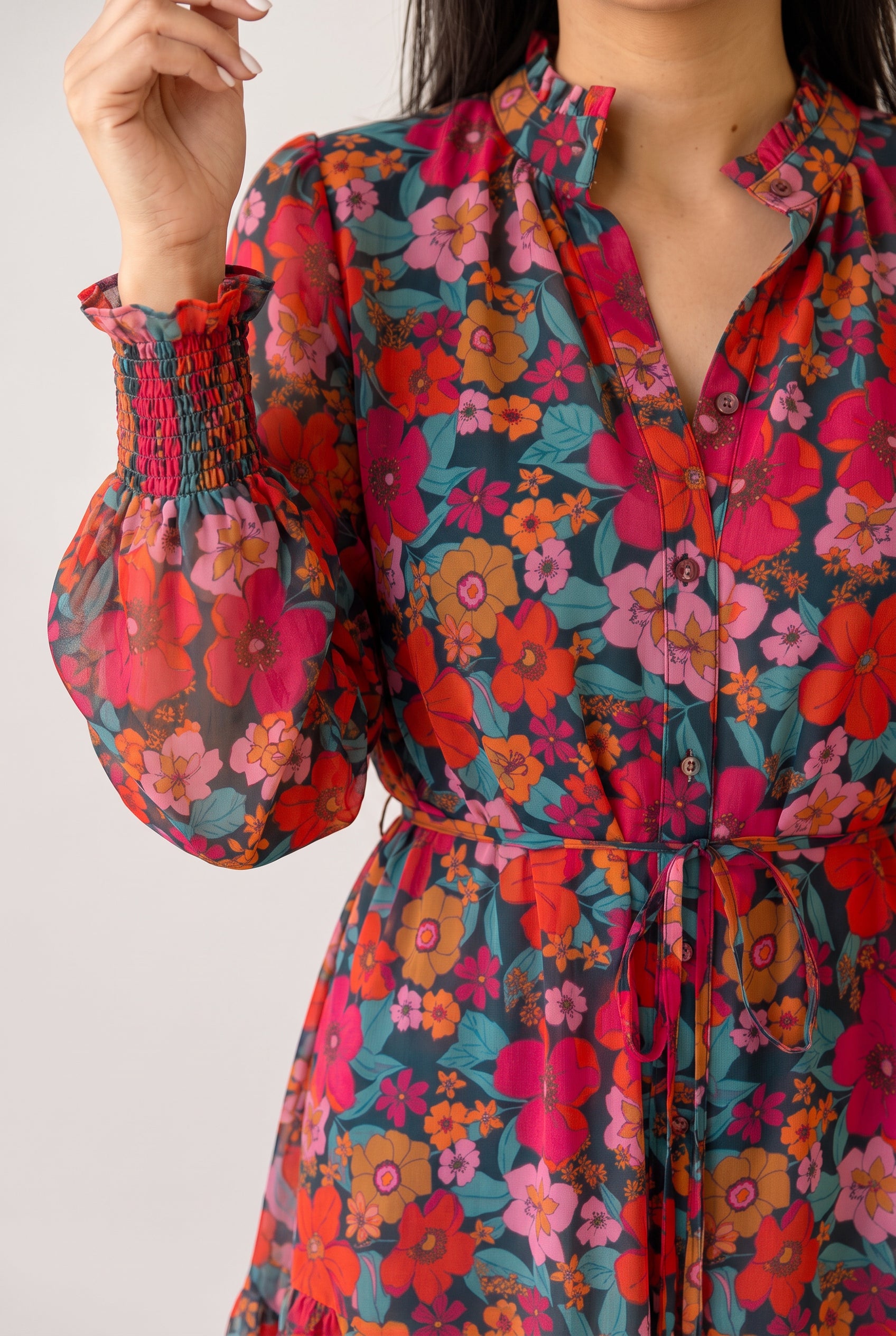 Neckline, buttons and smocked cuff of the Only If You Knew Floral Dress, showing the sheer printed sleeve.