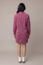 Straight back view of the Small mauve corduroy shirt dress showing the yoke, center fold and raw mini hem.