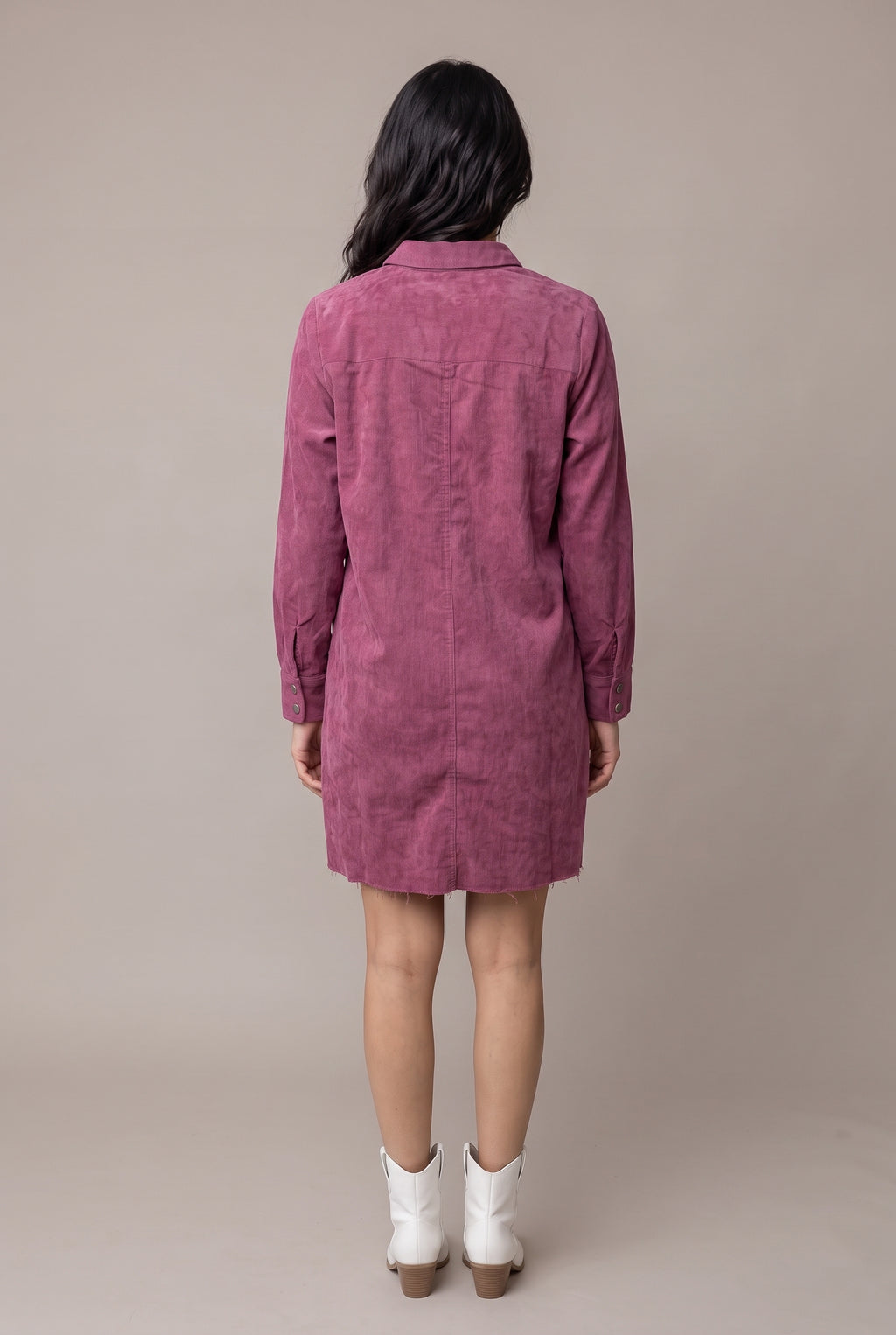Straight back view of the Small mauve corduroy shirt dress showing the yoke, center fold and raw mini hem.