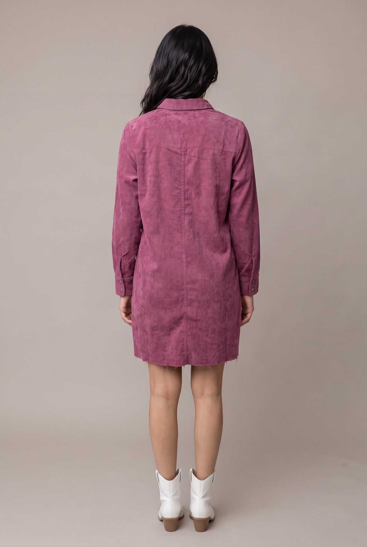 Straight back view of the Small mauve corduroy shirt dress showing the yoke, center fold and raw mini hem.