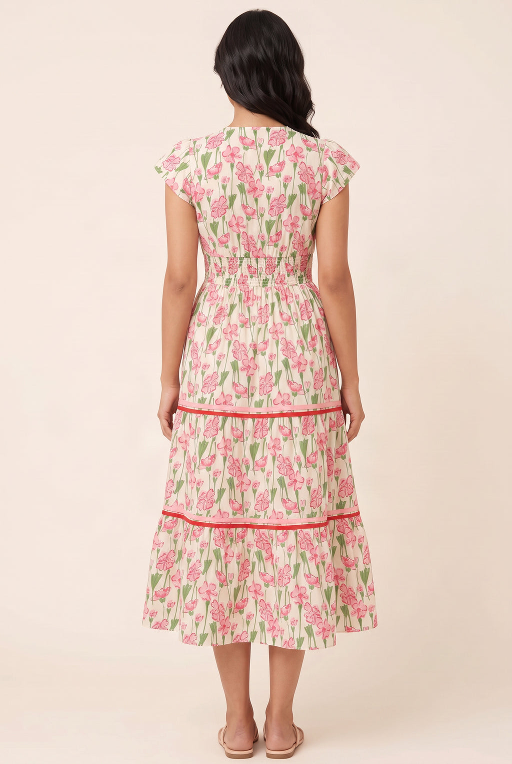 Back fit of the floral poplin tiered dress showing its shirred waist and midi skirt.