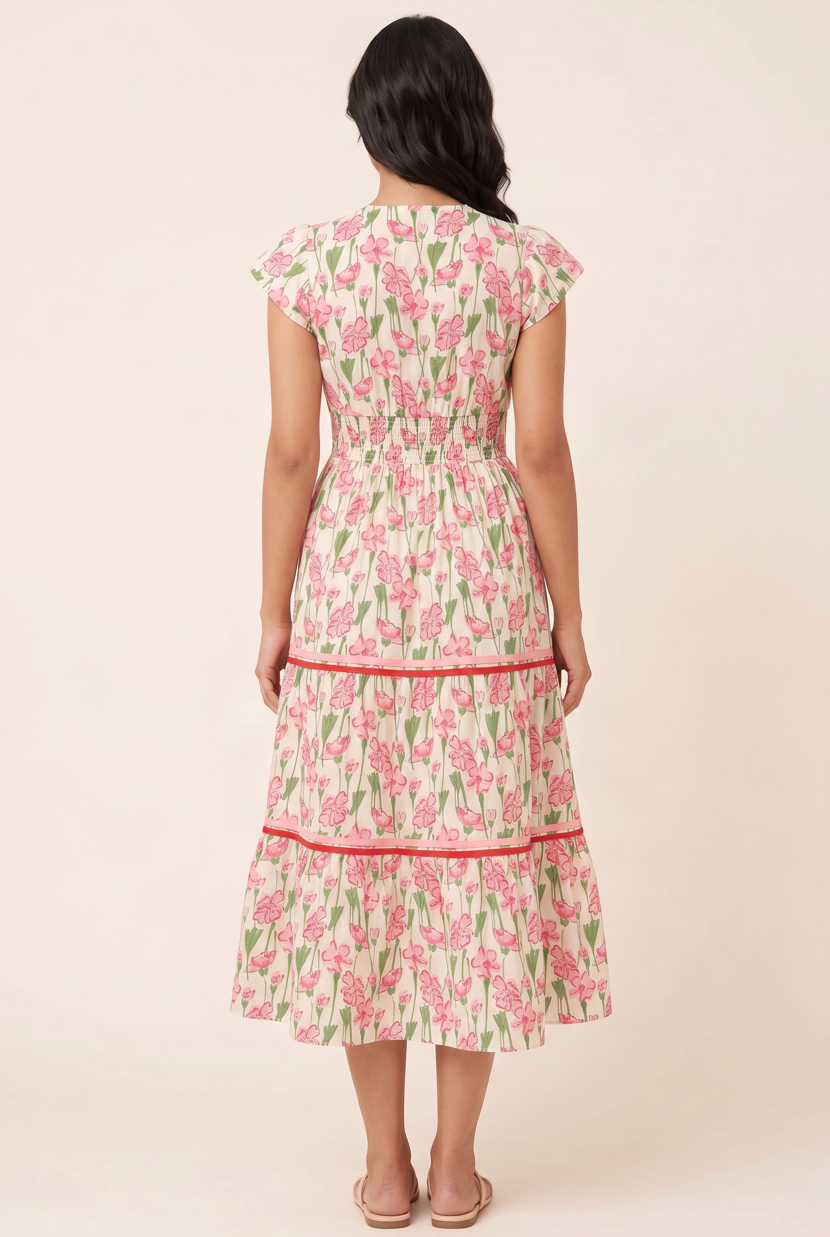 Back fit of the floral poplin tiered dress showing its shirred waist and midi skirt.