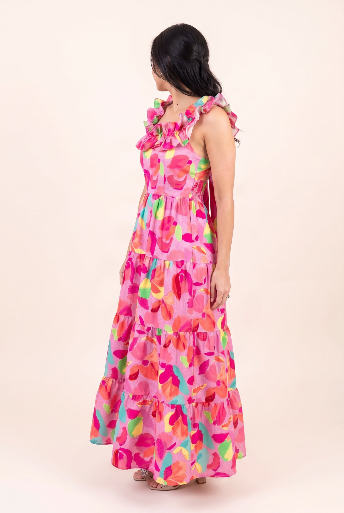 Angled side view of Blooming Affair floral maxi dress showing armhole coverage, waist and skirt volume.
