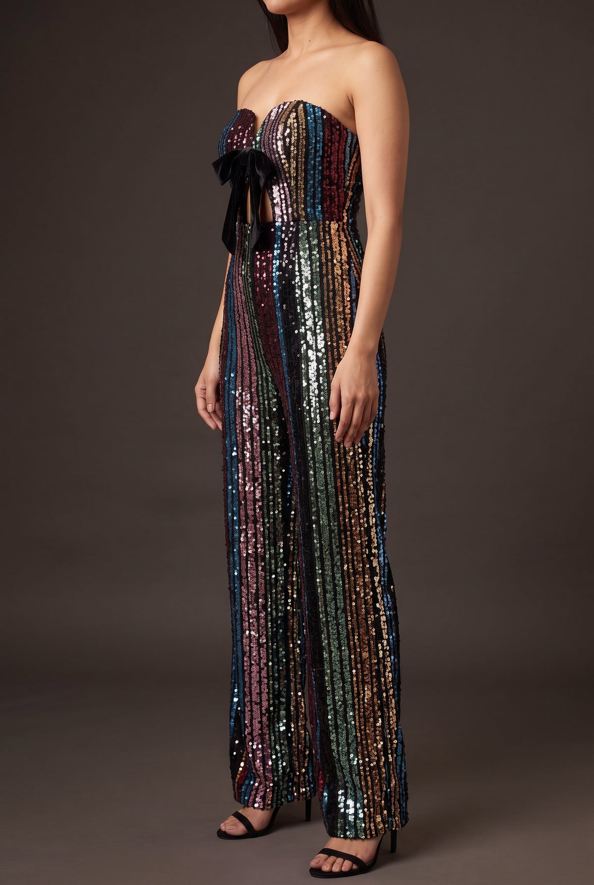 Angled side fit of the Don't Start Now sequin jumpsuit showing its fitted bodice and wide leg.