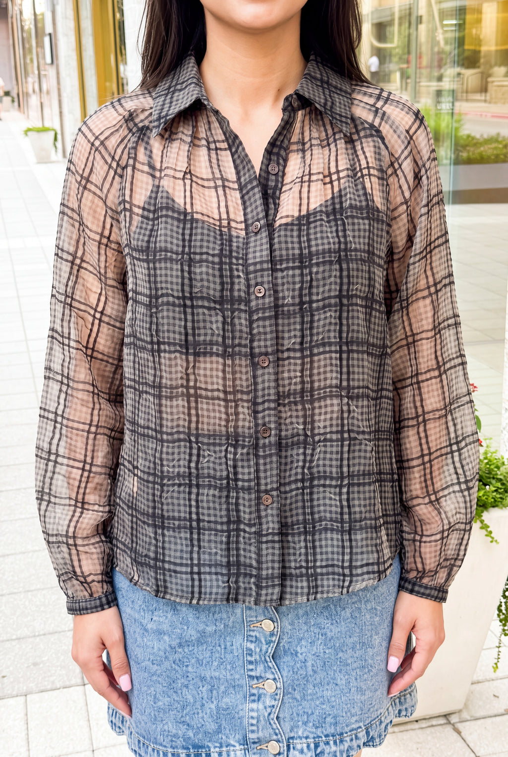 Sheer plaid, crinkled texture, dark buttons and gathered cuff of the Just Looking blouse.