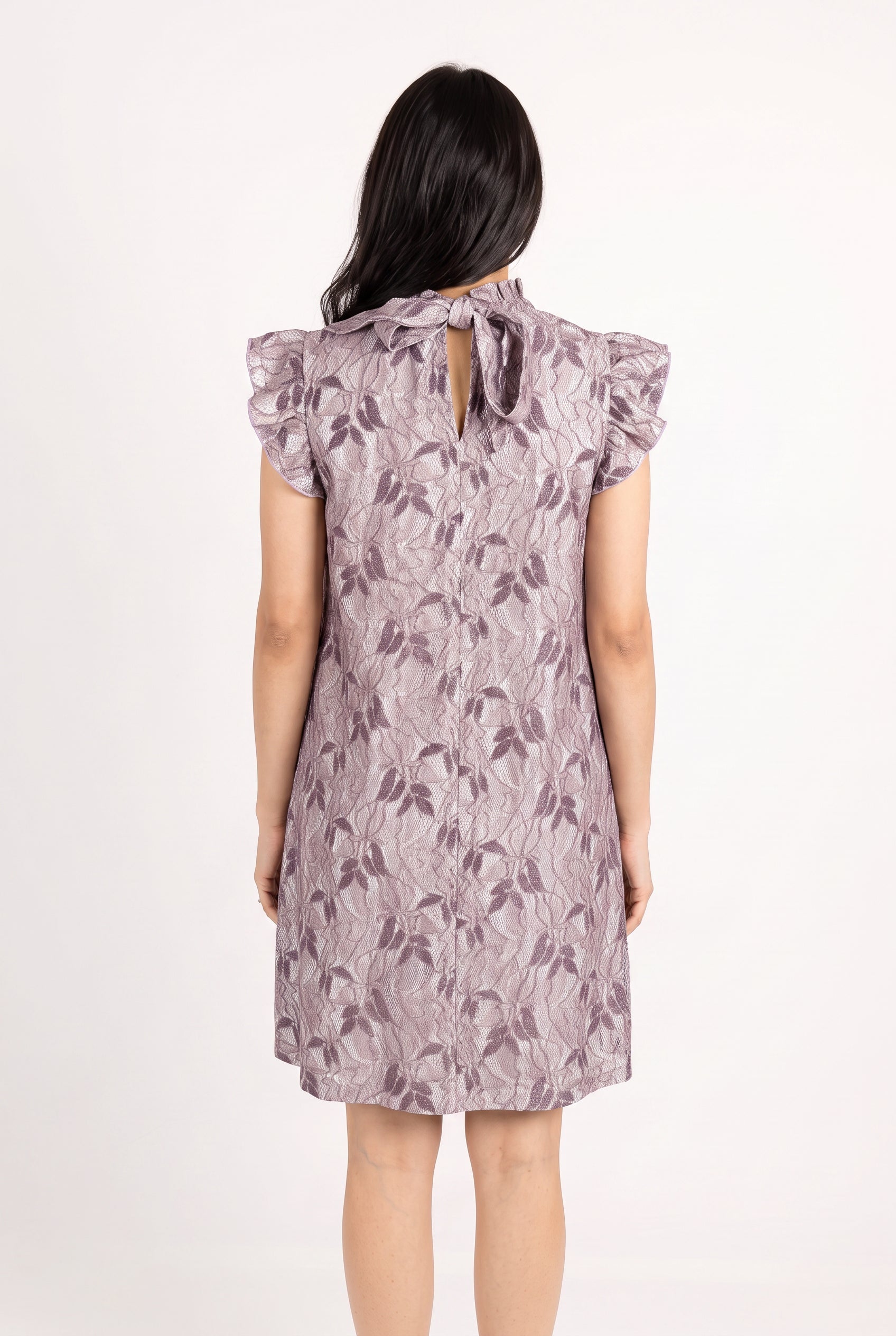 Back view of the Lavender For the First Time Shift Dress showing its bow ties and keyhole fastening.
