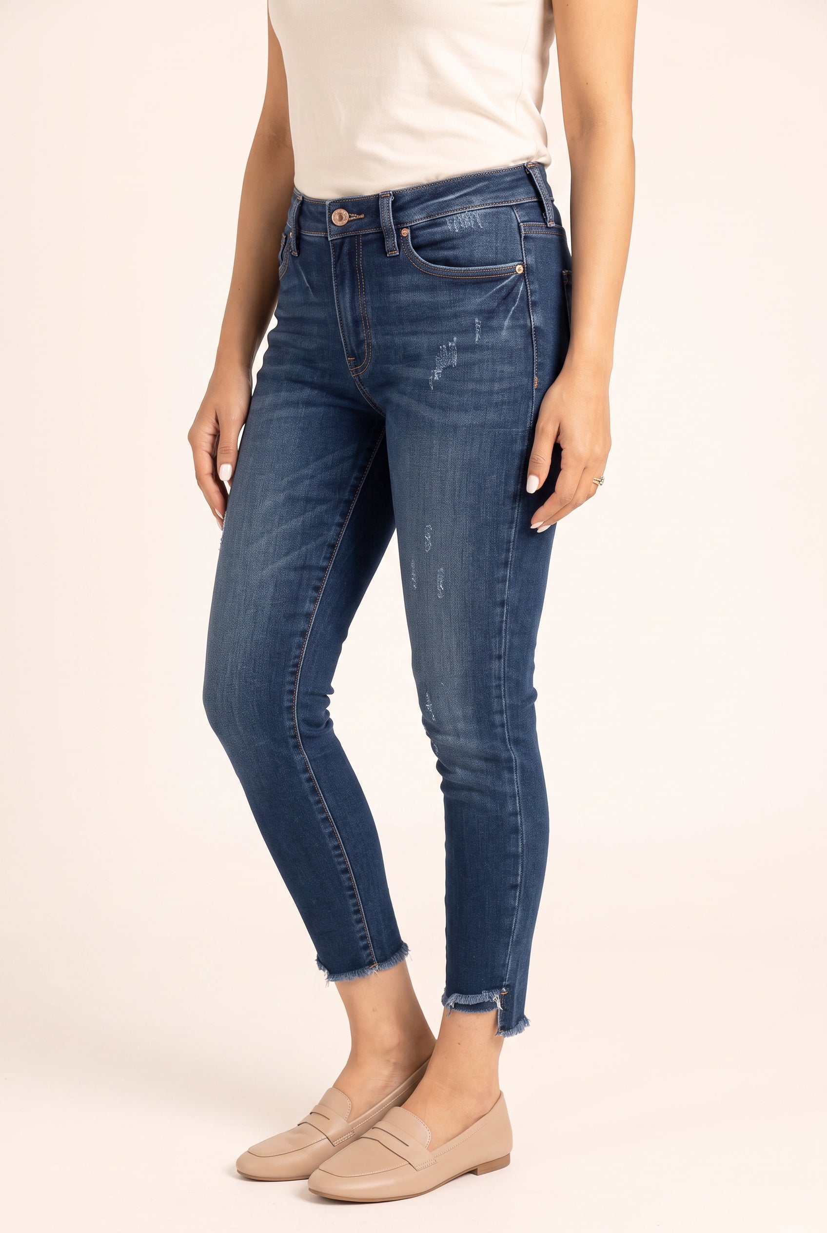 Angled side view of Beautiful Day Mid Rise Ankle Jeans showing the close leg fit and ankle crop.