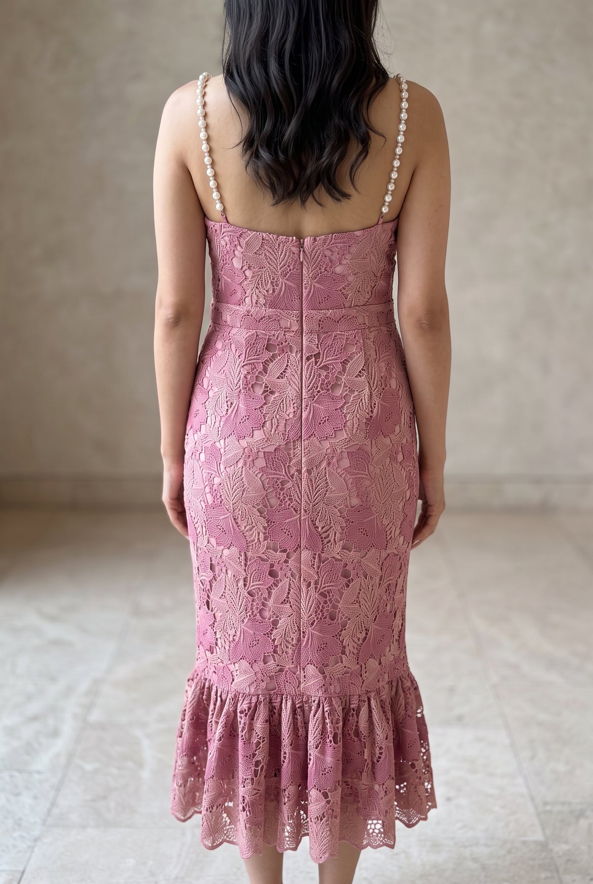 Back view of the pink lace mermaid dress showing its low back and center zipper.