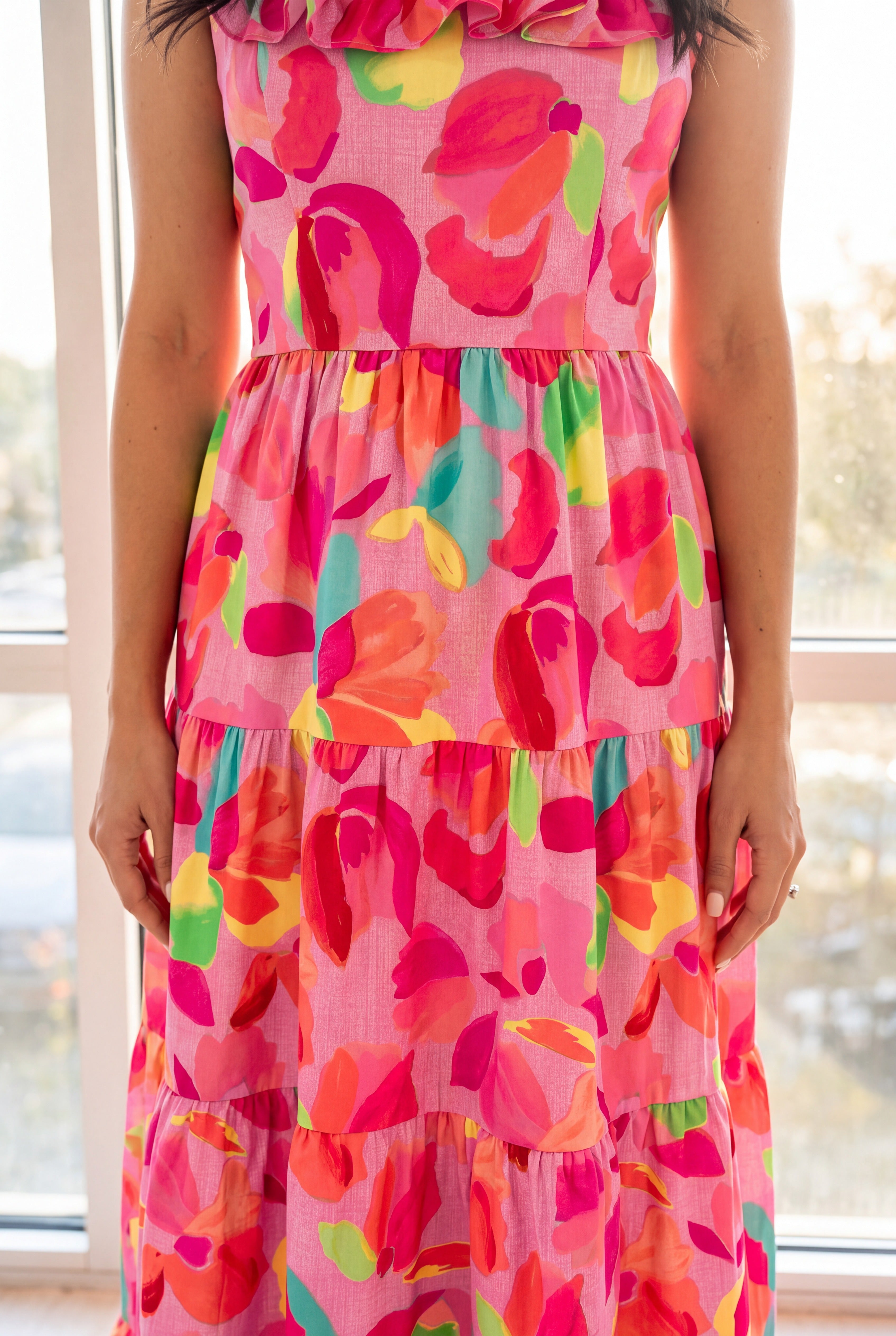 Close view of Blooming Affair floral maxi dress showing the polyester texture, tier seam and opacity.