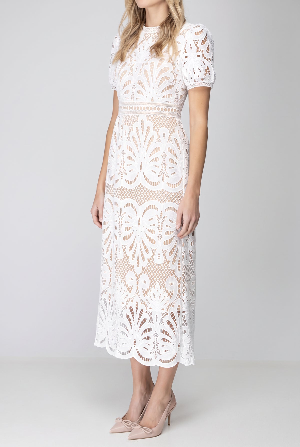 Angled side fit of the white crochet lace midi dress showing the shaped waist and A-line fall.
