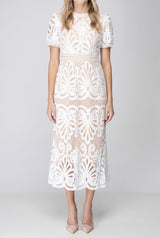 Front fit of the white crochet lace midi dress showing its waist, A-line skirt and scalloped hem.