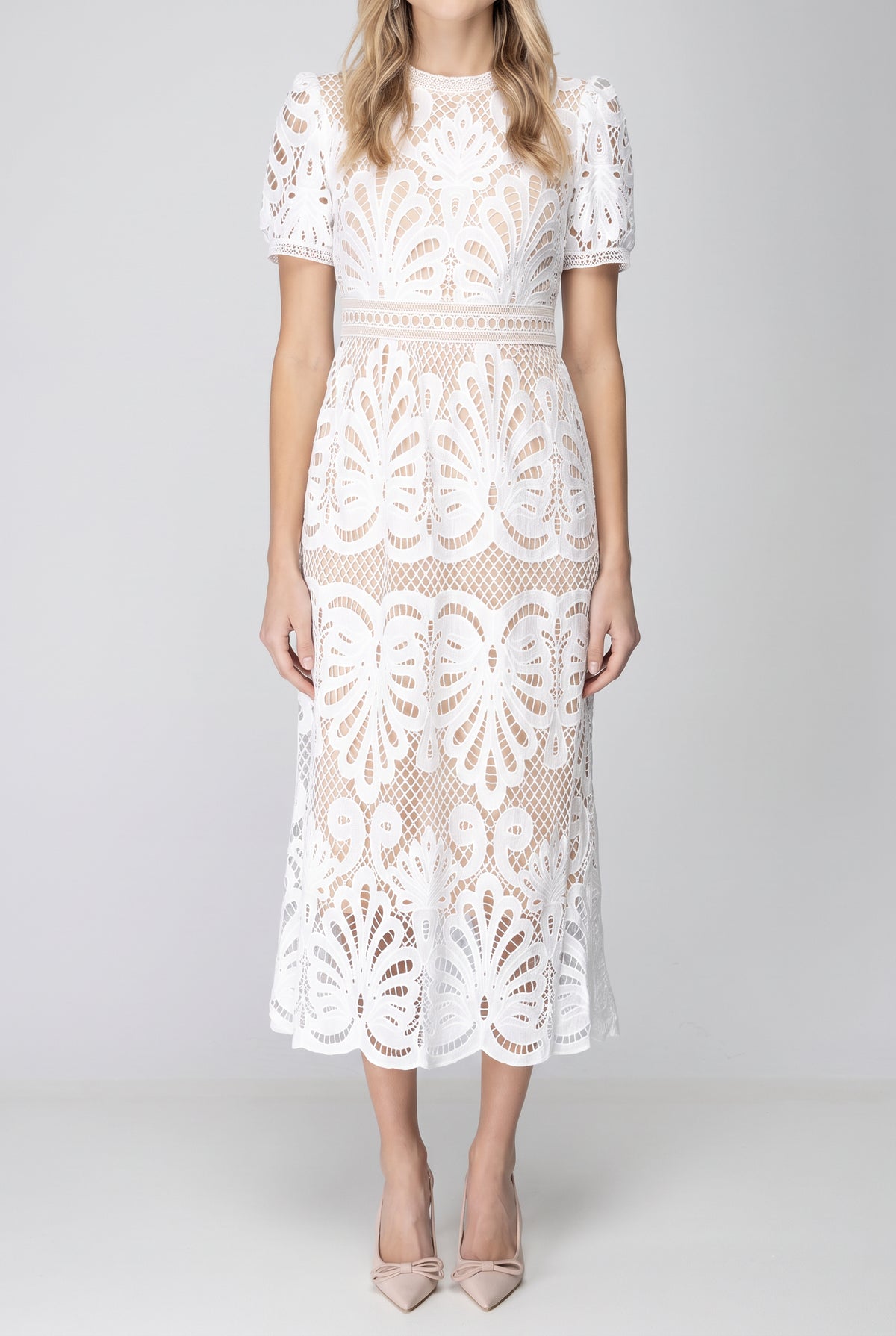 Front fit of the white crochet lace midi dress showing its waist, A-line skirt and scalloped hem.