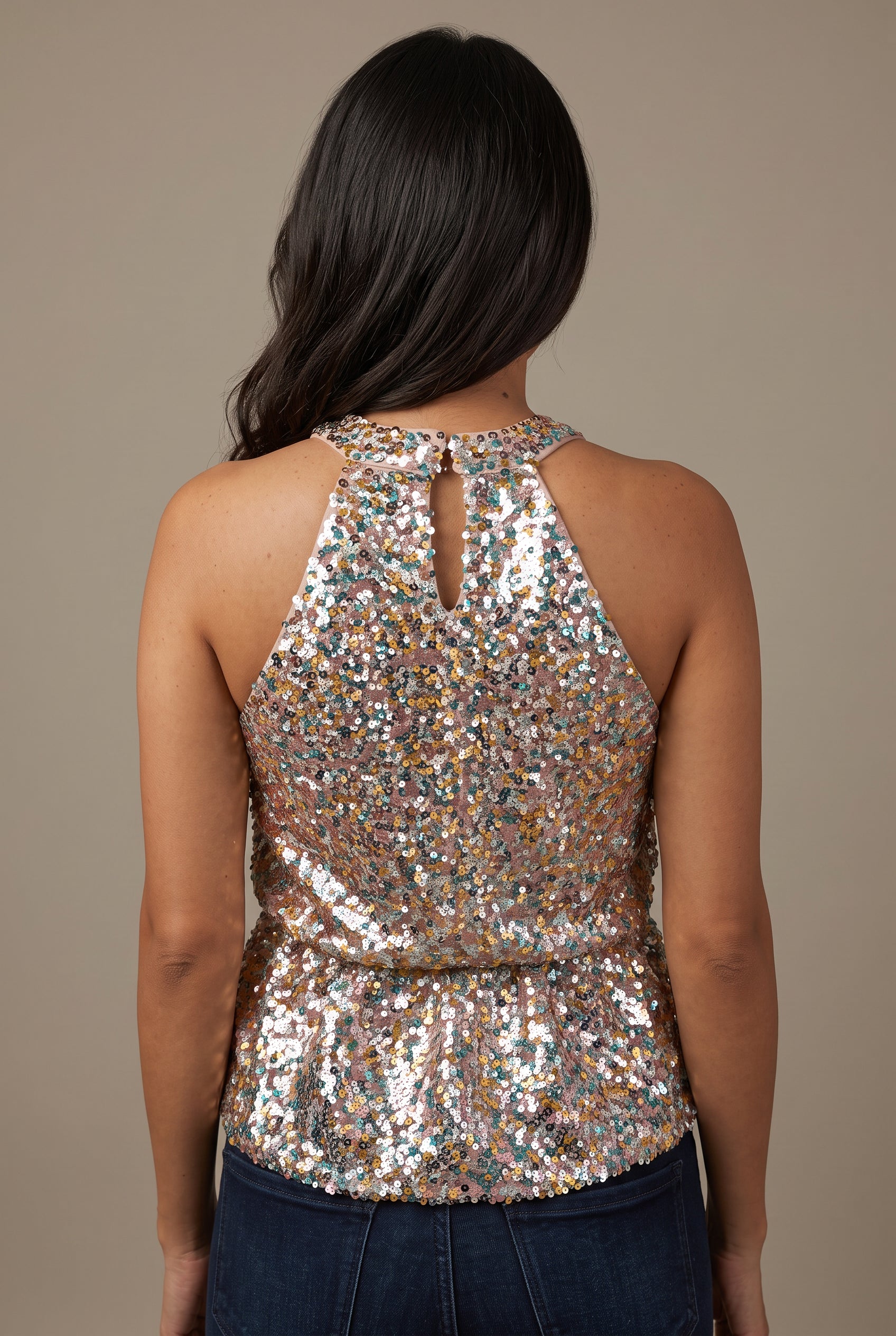 Back of the Last Night Sequin Halter Top showing its keyhole, waist seam and flared hem.