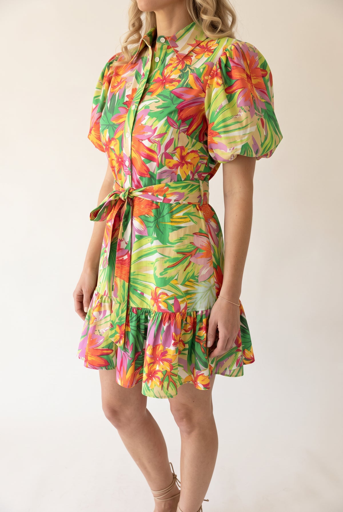 Angled side fit of the Chase Your Own Sunshine dress showing its puff sleeve and short flared skirt.