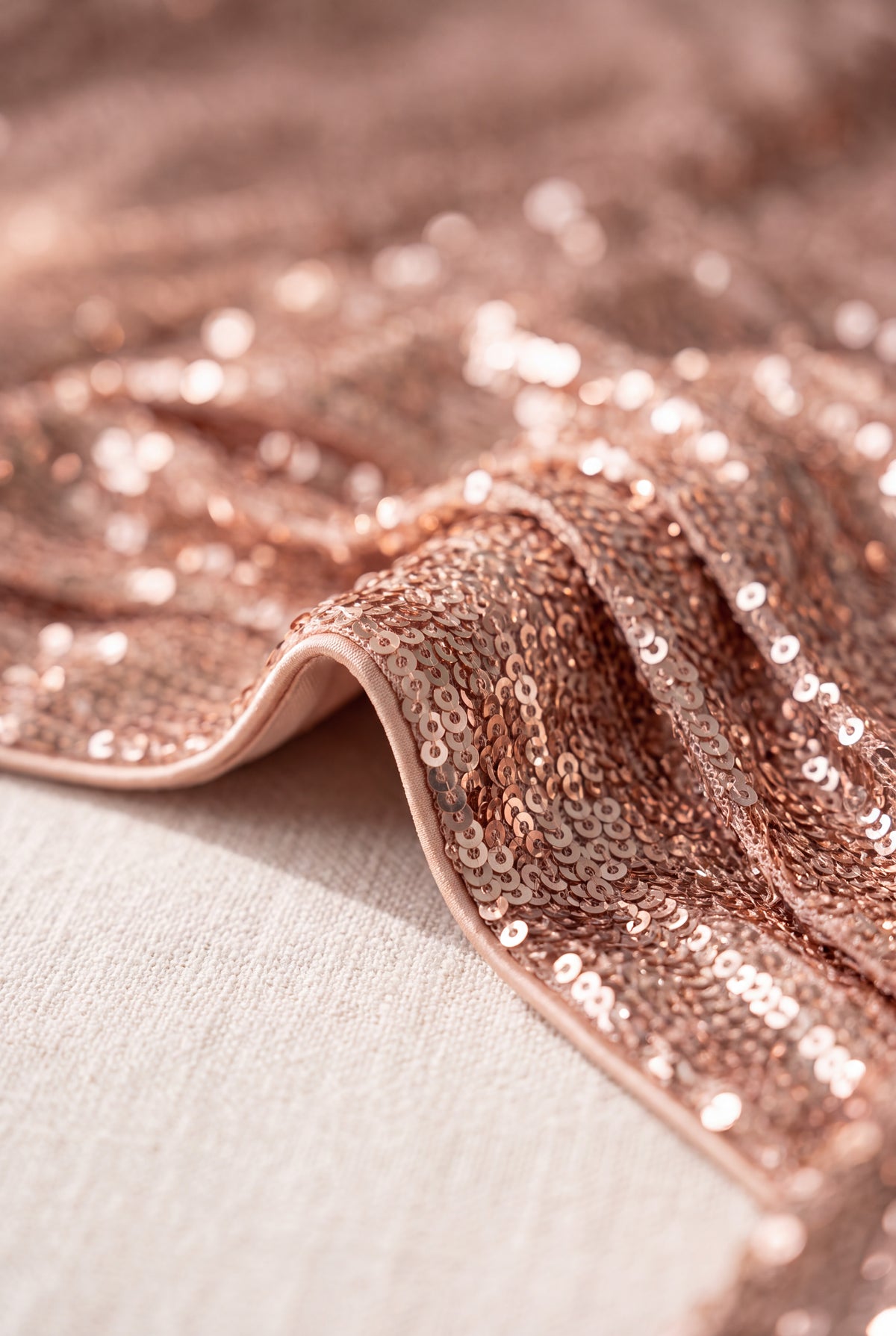 Close detail of the Cheap Thrills Mini Dress showing its rose-gold sequins and finished edge.