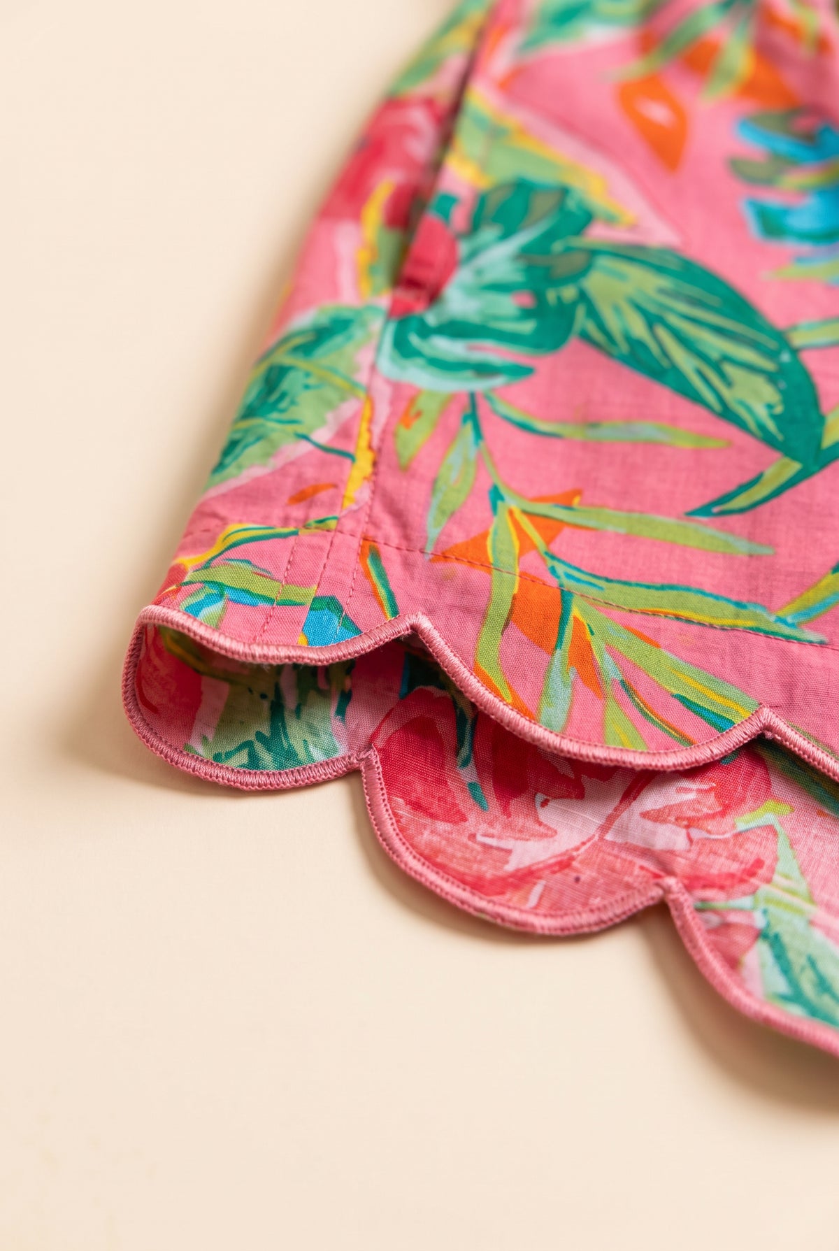 Close detail of the pink floral cotton and stitched scalloped hem on the Bring Me to Life Shorts.