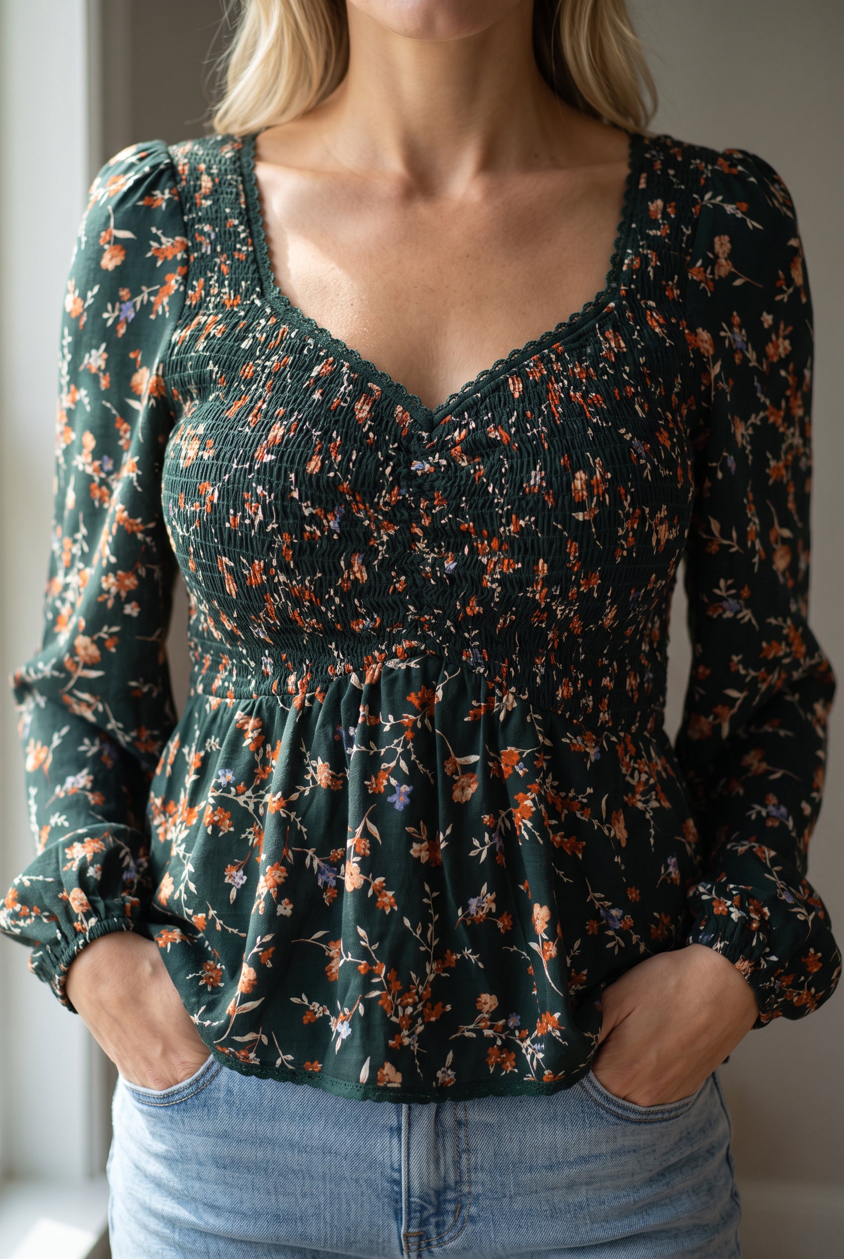 Close view of the floral top's sweetheart trim, print and elastic smocking on the fitted bodice.